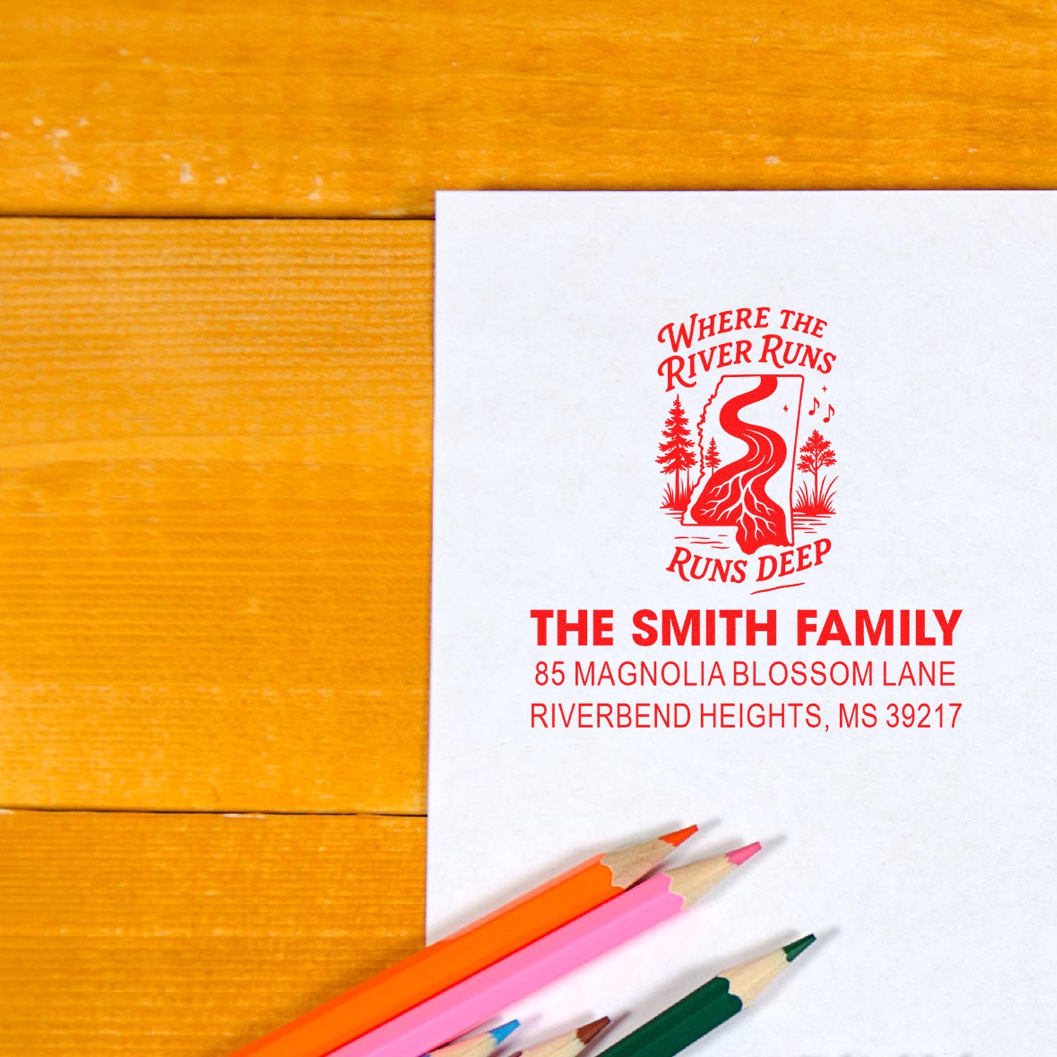 Custom return address rubber stamp with The Smith Family name, river design and address on stationery for personalized mailings.