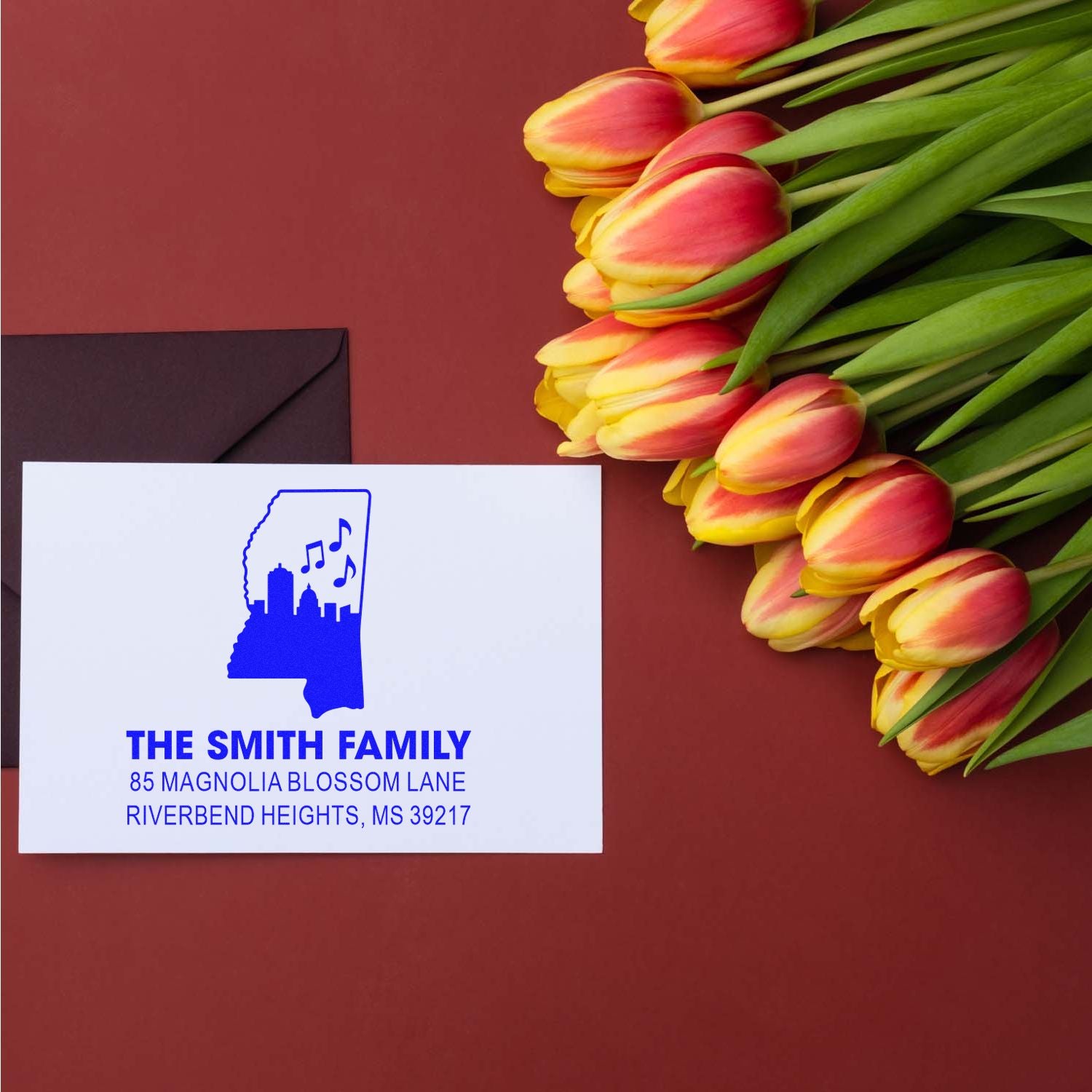 Custom return address rubber stamp sample for The Smith Family, featuring Mississippi skyline and music-note design.