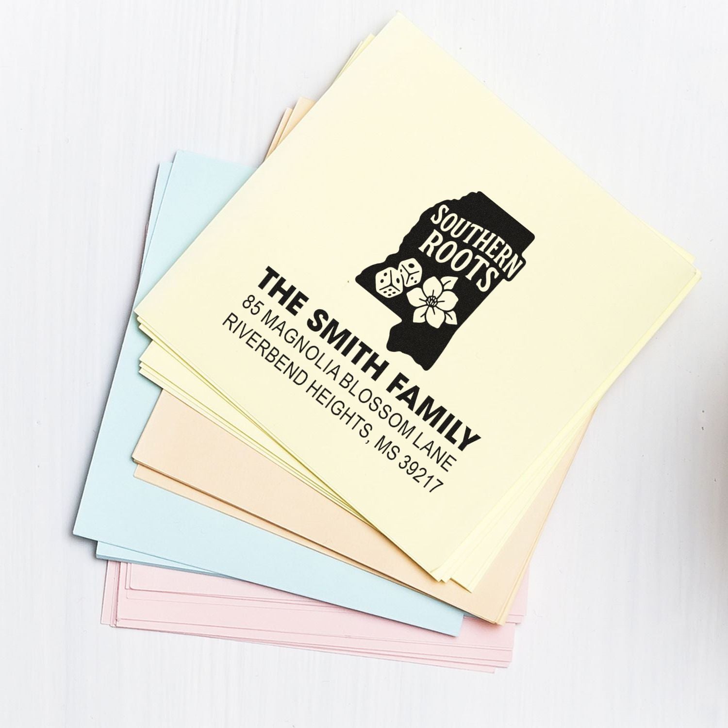 Custom address rubber stamp on pastel envelopes for The Smith Family, showing personalized mailing and return address design.