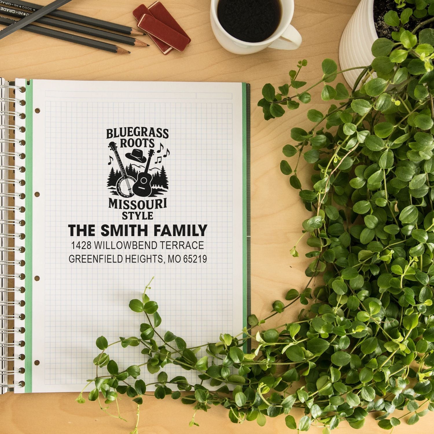 Custom rubber stamp mockup showing a personalized return address stamp with Bluegrass Roots Missouri Style design on notebook paper.