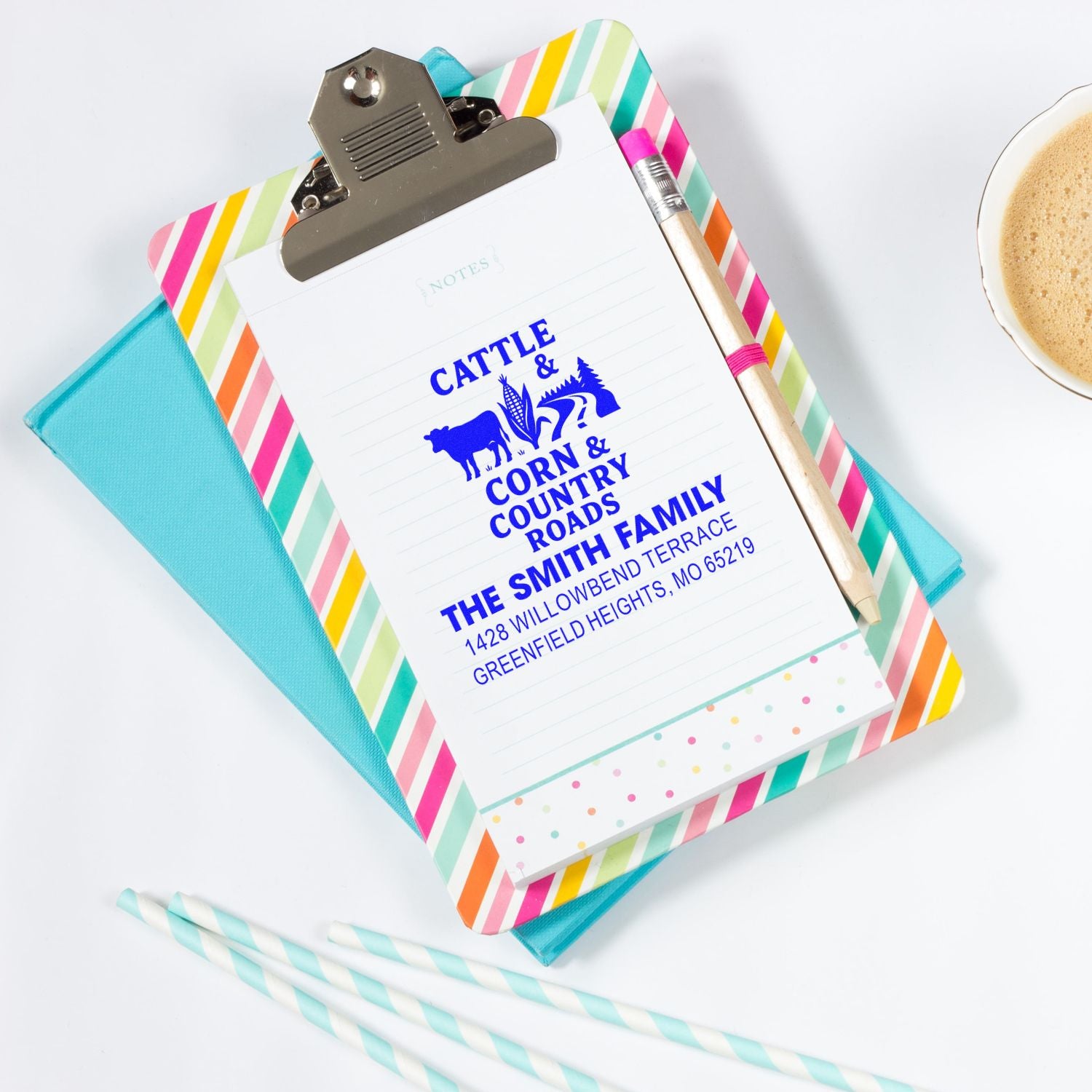 Custom rubber address stamp on clipboard shows Cattle & Corn & Country Roads family return address for farmhouse stationery.