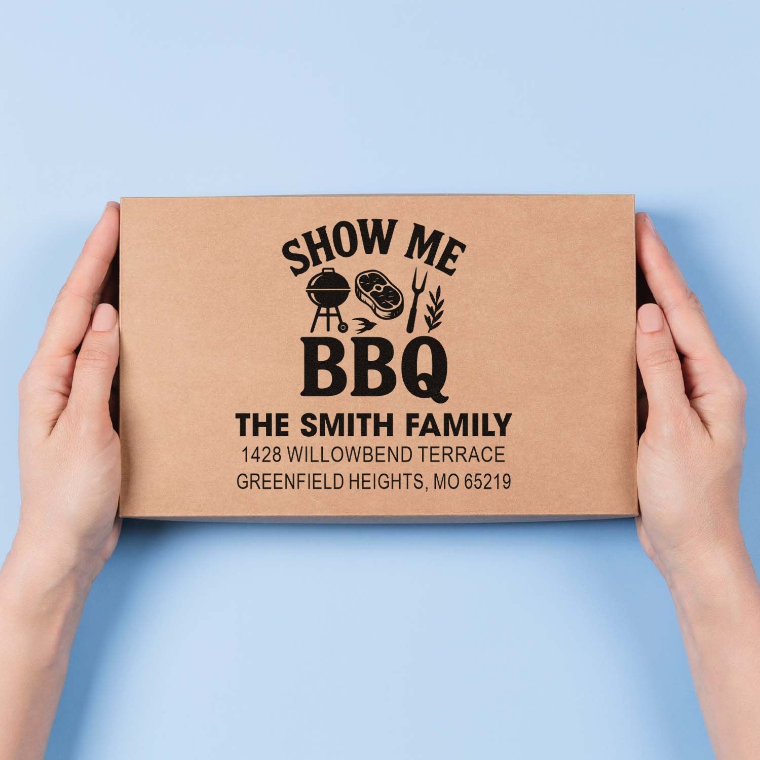 Custom BBQ rubber stamp on kraft box with family name and address for personalized packaging.