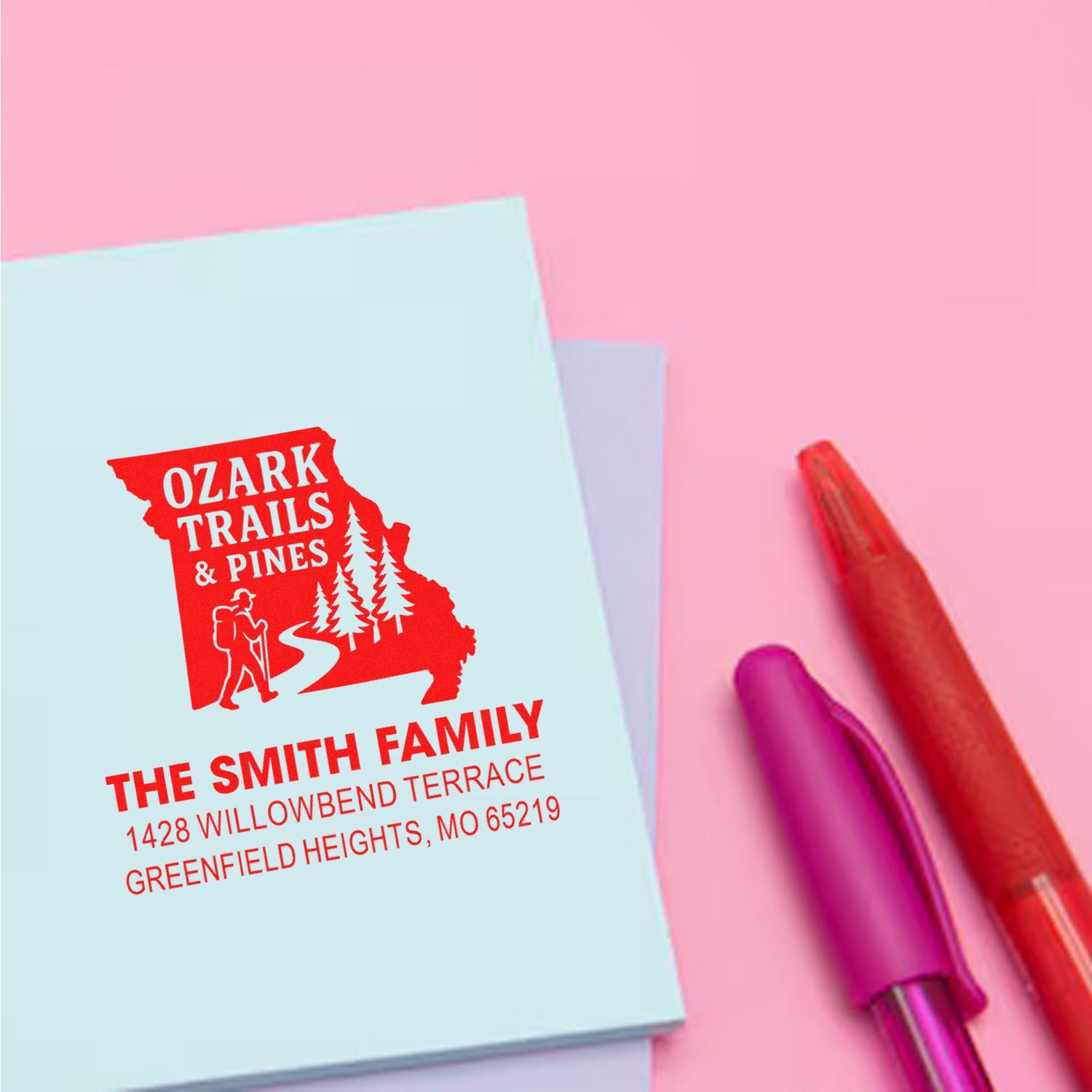 Custom rubber address stamp for The Smith Family with Ozark Trails & Pines design and Greenfield Heights, MO return address.