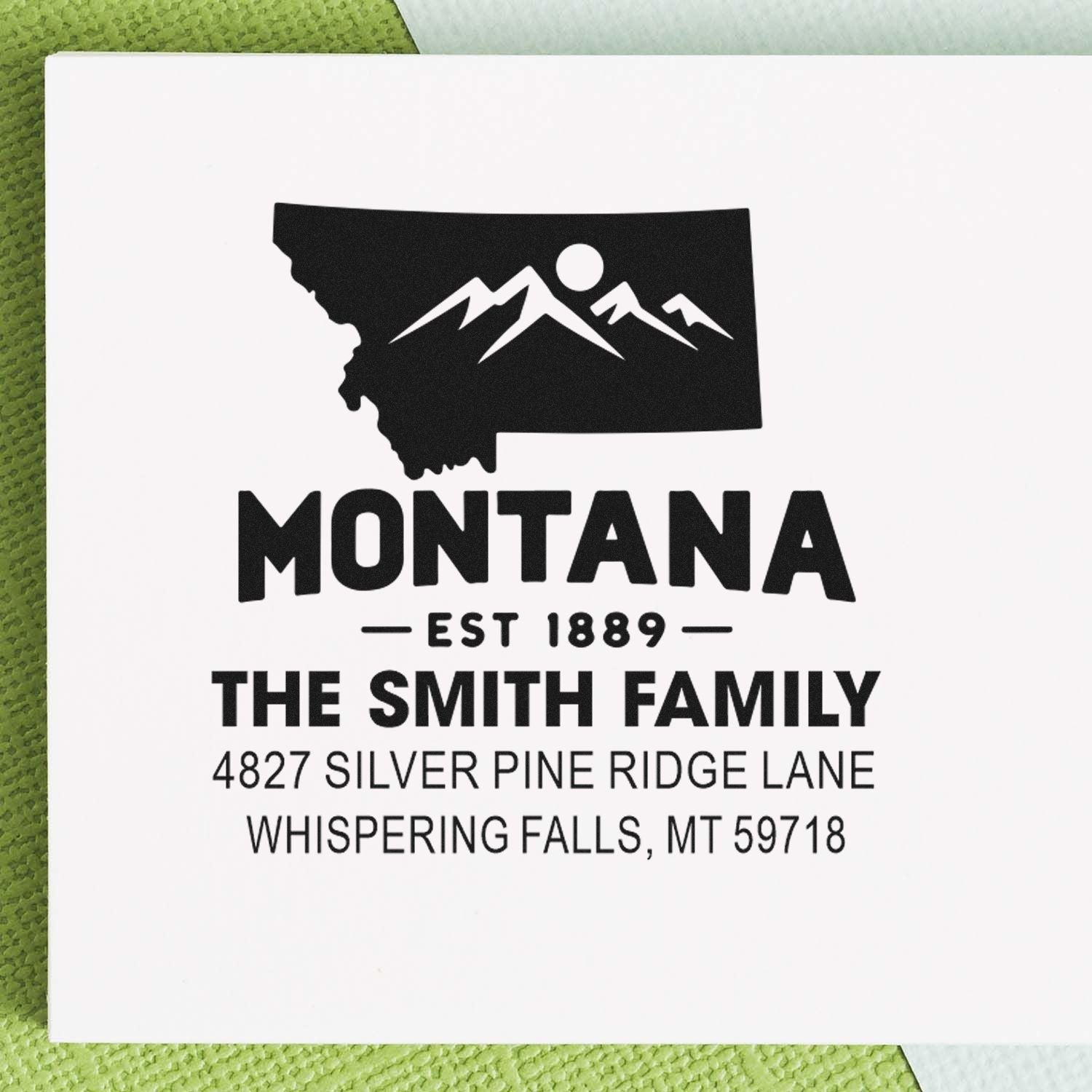 Custom Montana return address rubber stamp with mountain state design, family name, and address for personalized mailings.