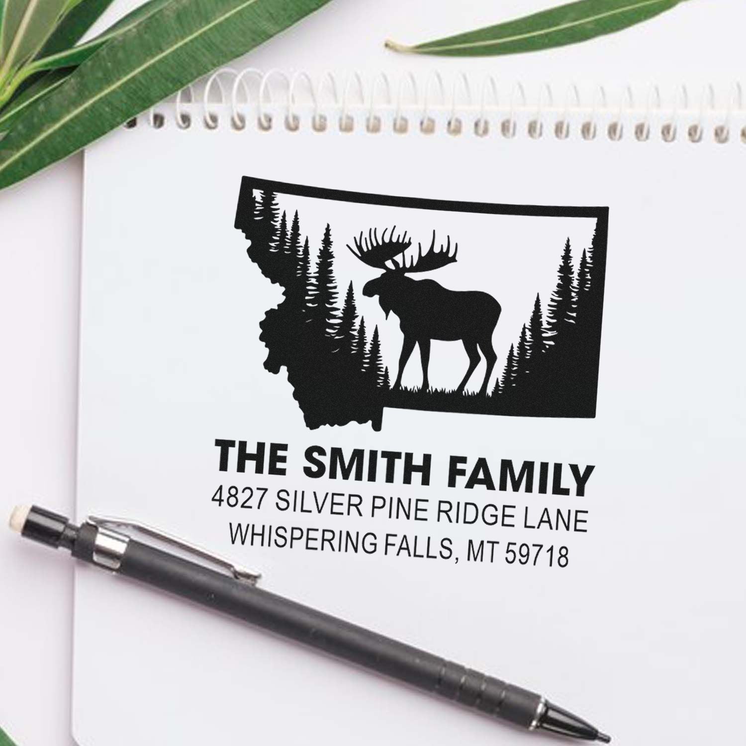 Personalized family address rubber stamp with Montana outline, moose, and pine forest design.