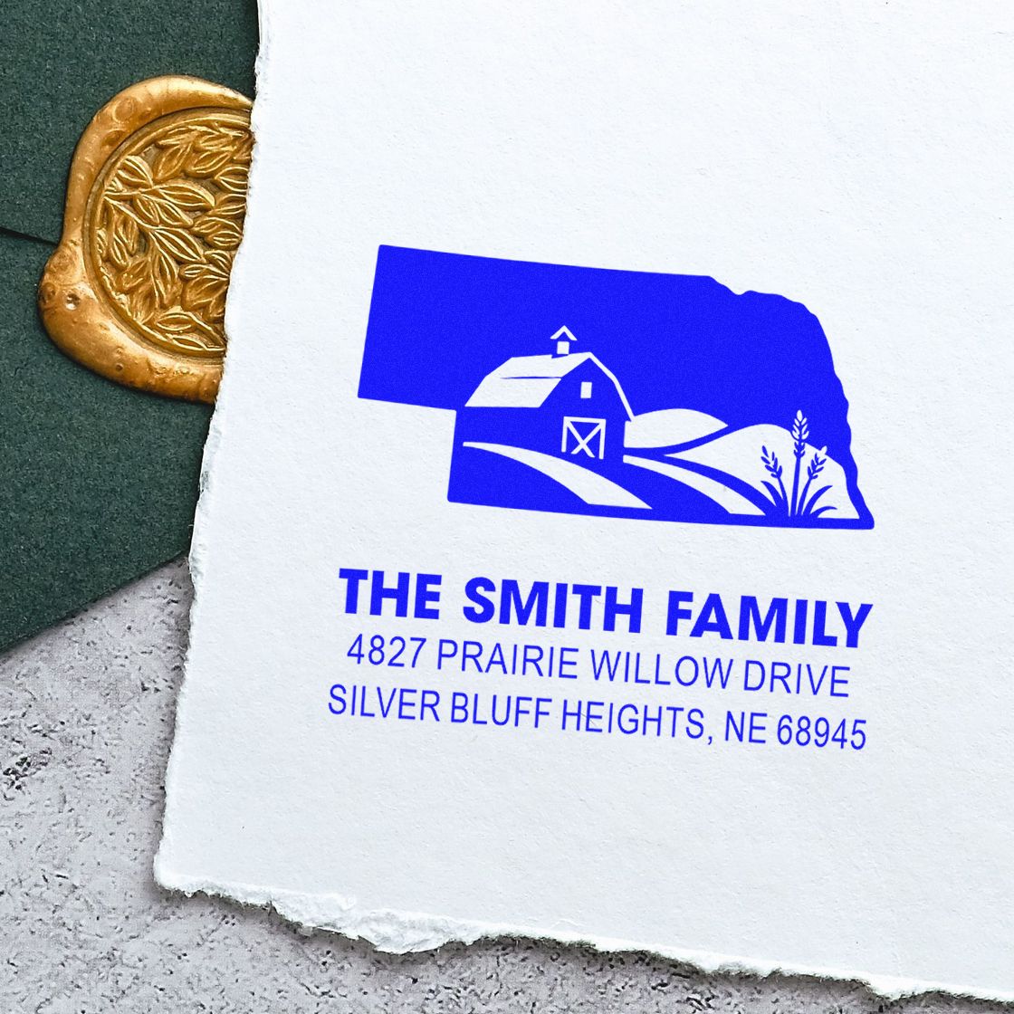 Custom return address rubber stamp with farmhouse logo and The Smith Family Nebraska address on white paper.