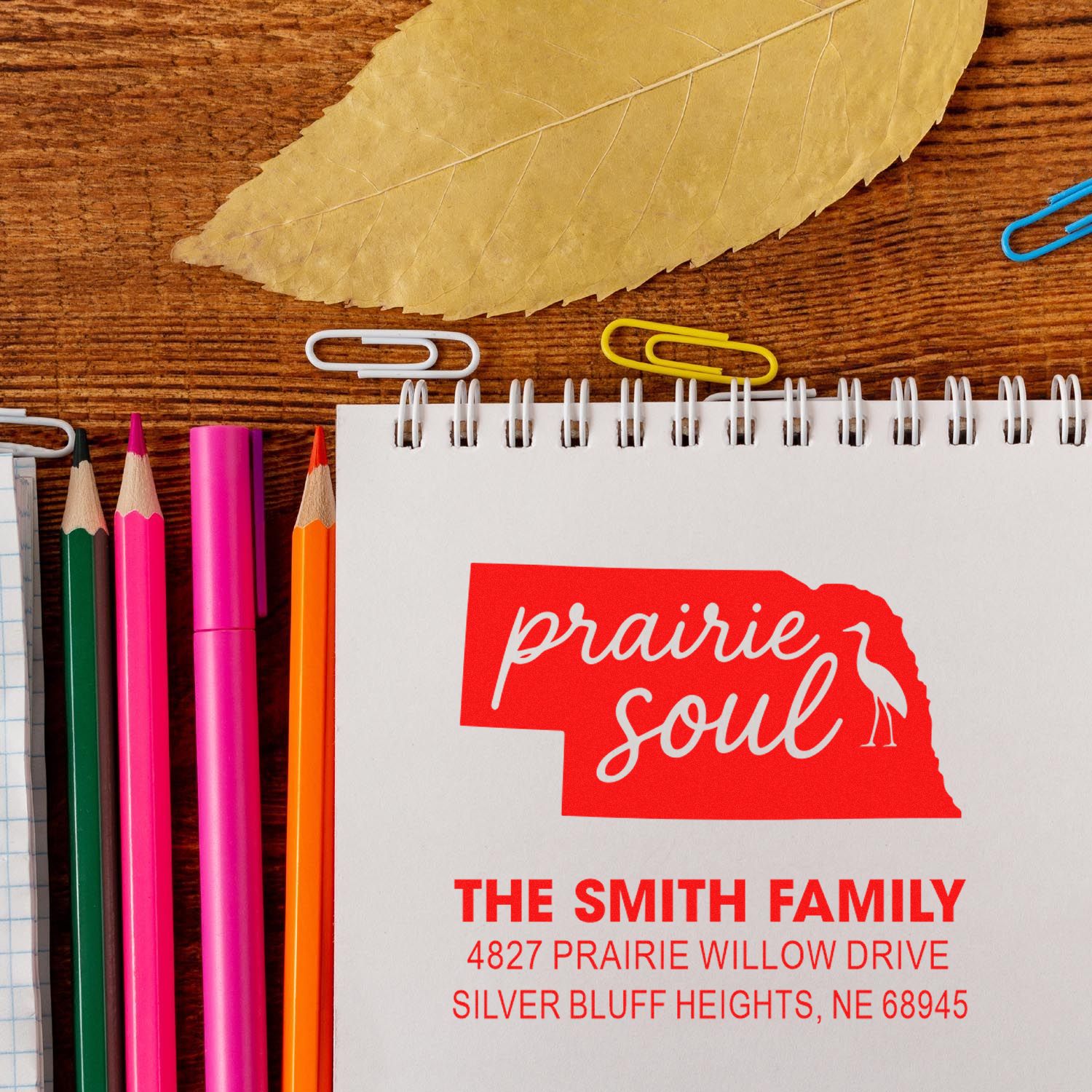 Custom rubber stamp design for The Smith Family with Prairie Soul Nebraska return address on a notebook.