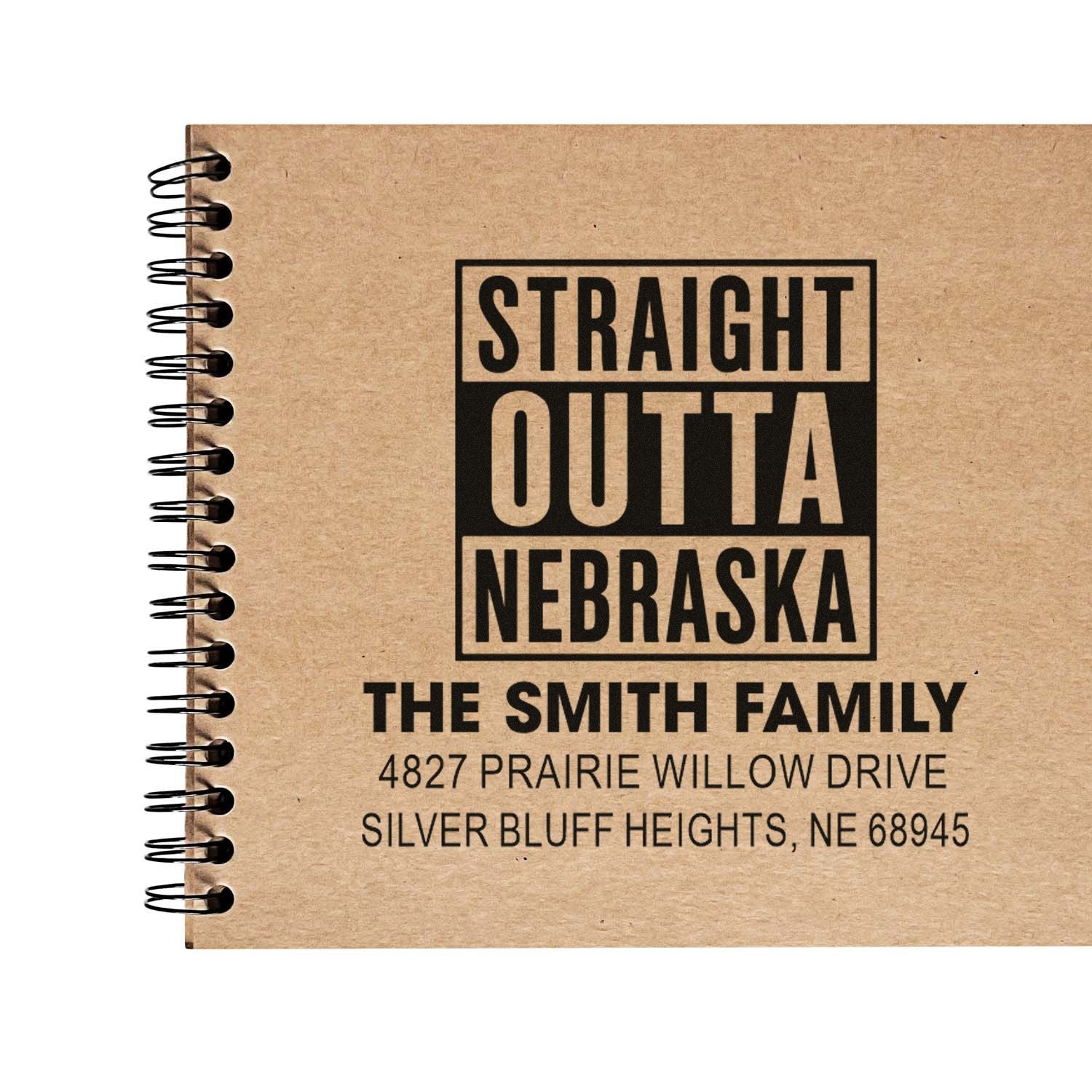 Personalized rubber stamp design with Straight Outta Nebraska, The Smith Family name, and return address on a notebook cover.