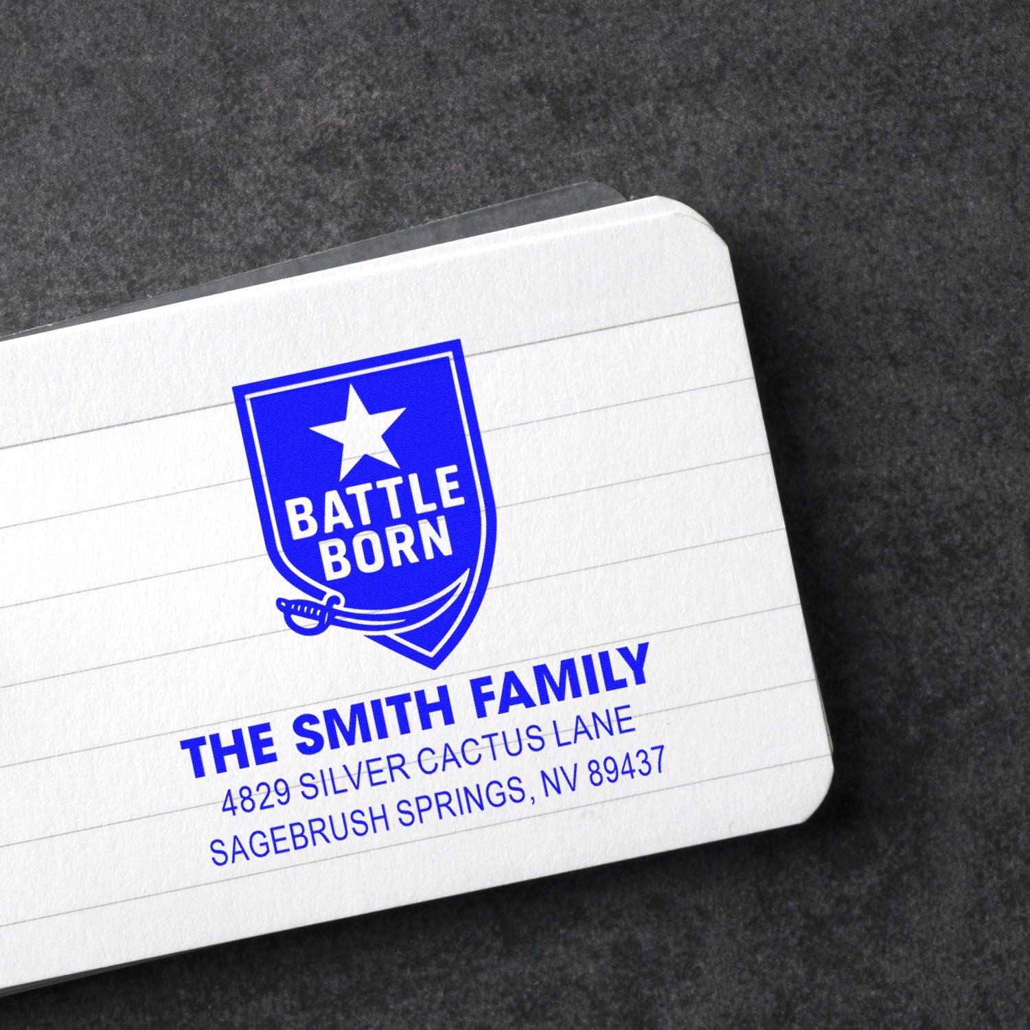 Custom return address rubber stamp for The Smith Family, with Battle Born shield logo and Nevada address.