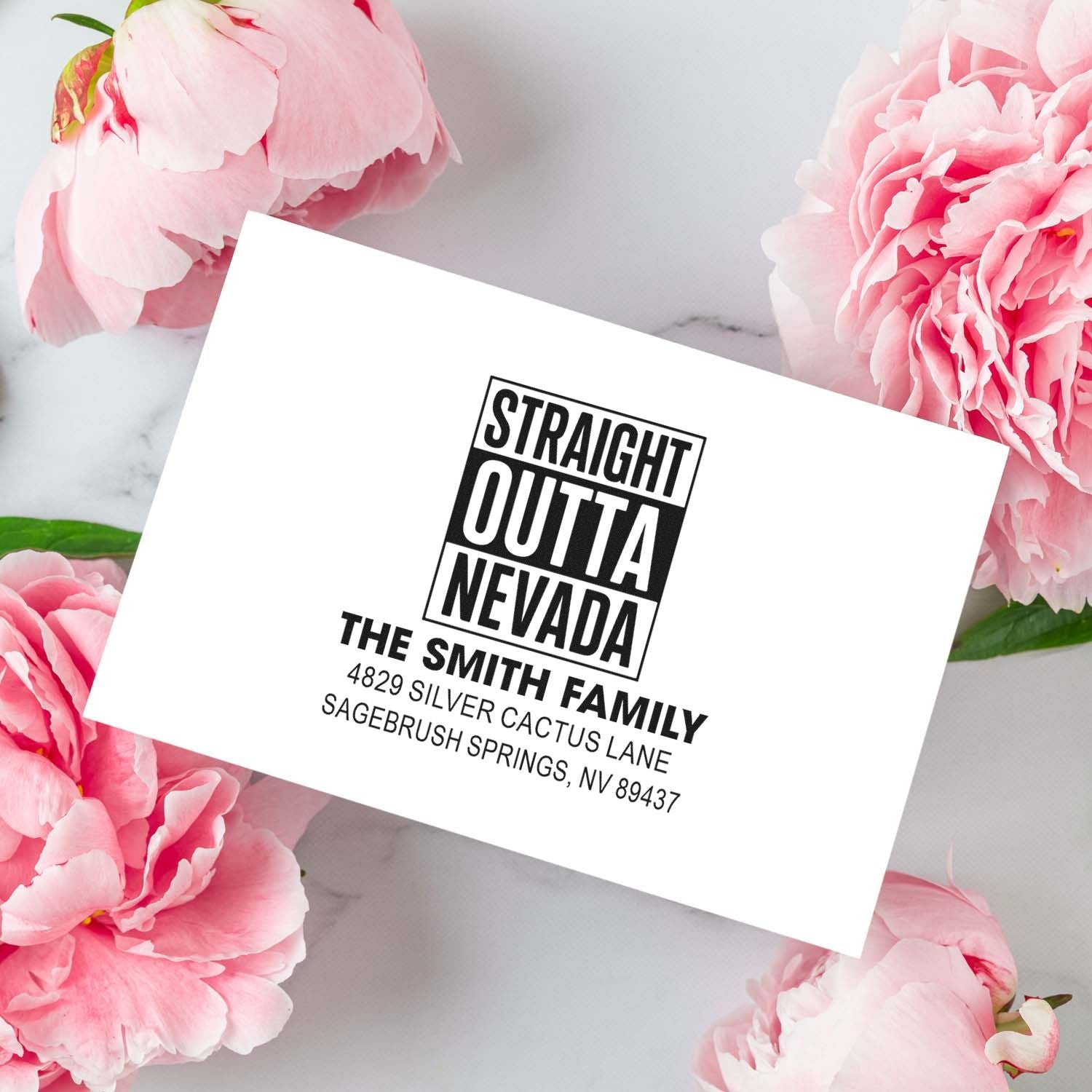 Custom rubber address stamp with Straight Outta Nevada design for The Smith Family, ideal for personalized mailing envelopes.