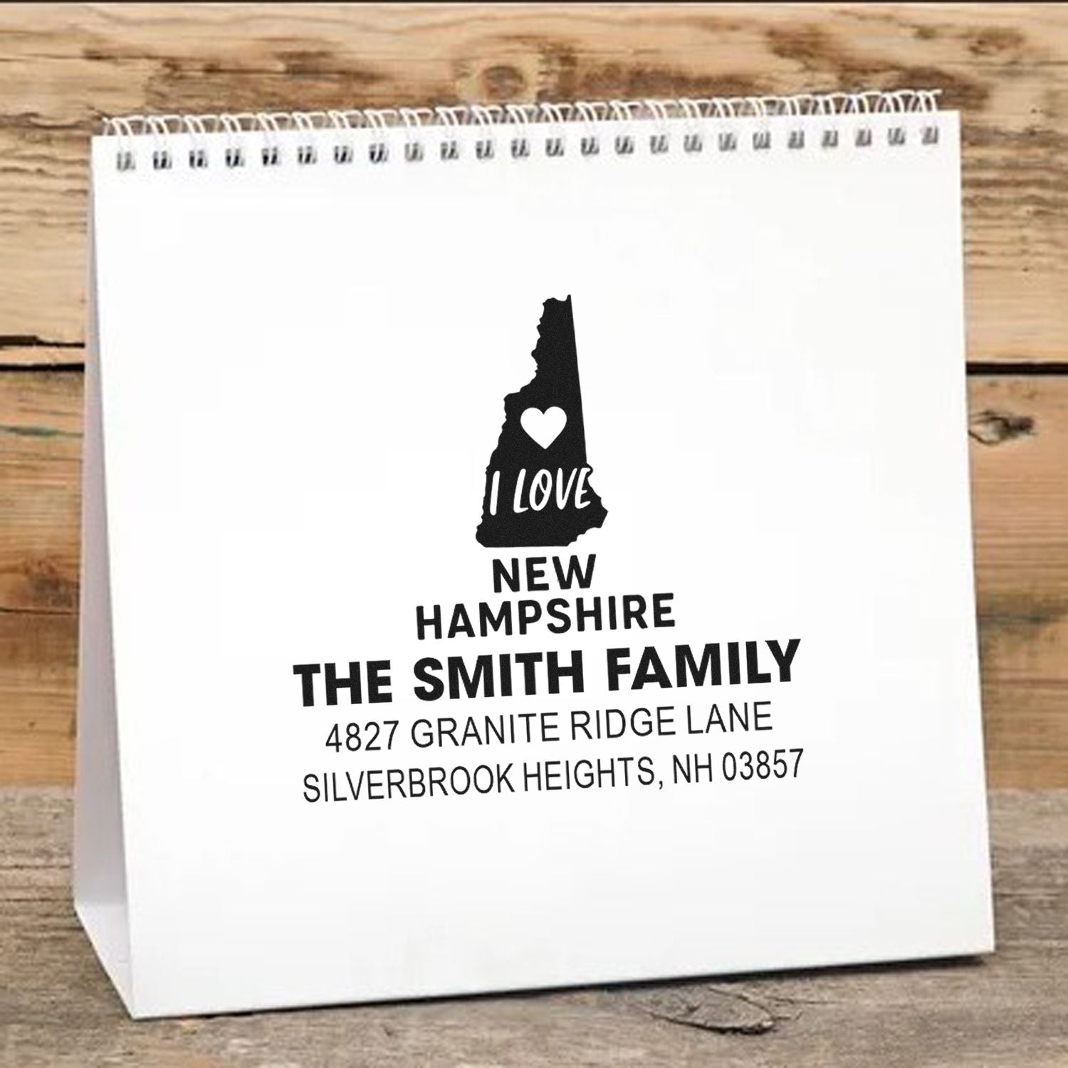 Personalized New Hampshire rubber stamp design for The Smith Family, with state silhouette, heart, and custom address.