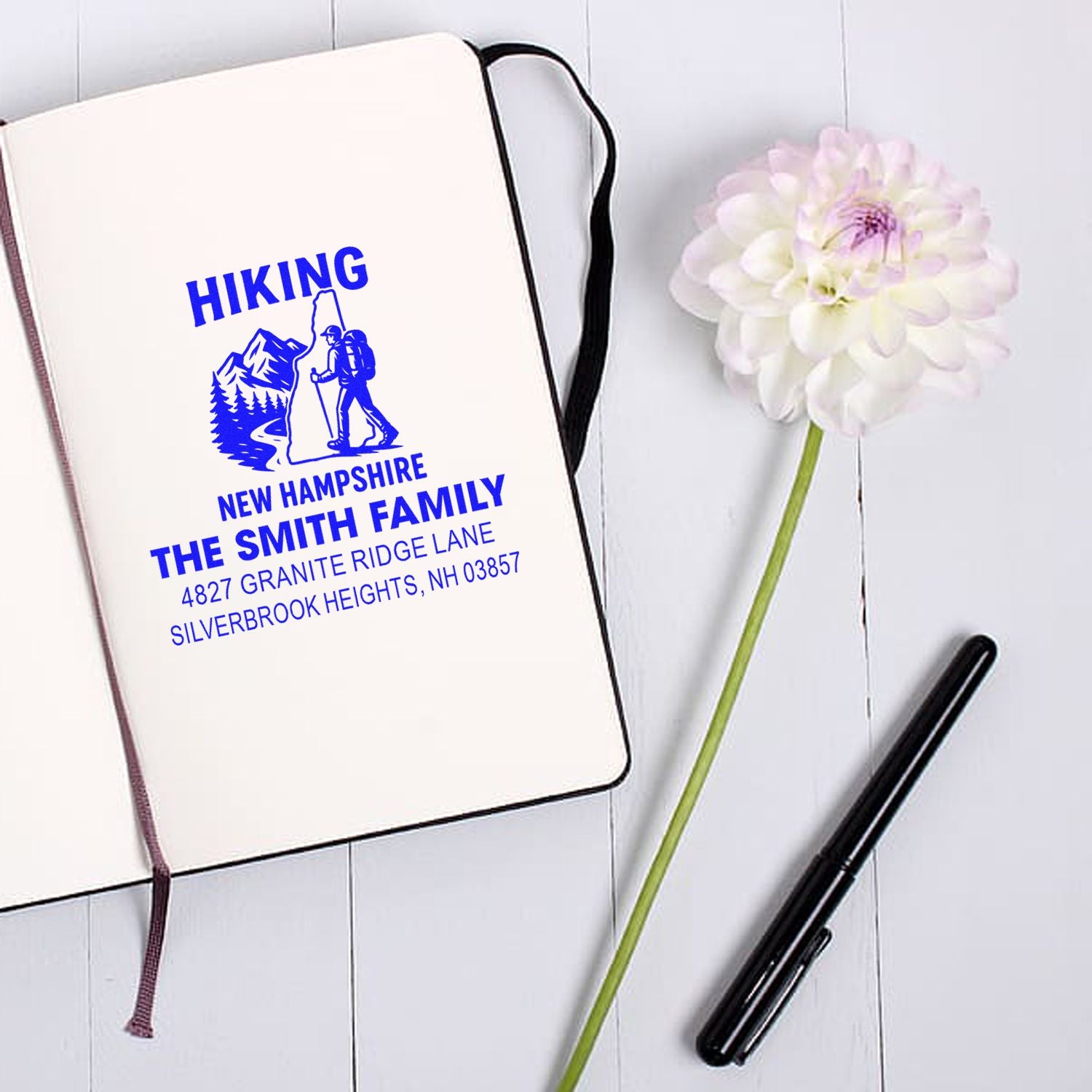 Custom hiking rubber stamp with family name and address, featuring a New Hampshire mountain design for personalized stationery.