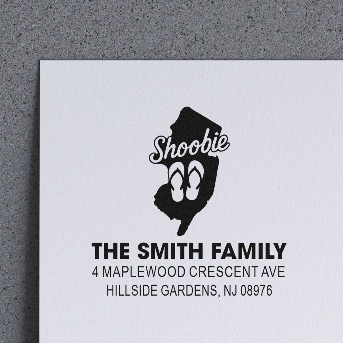 Custom family return address rubber stamp with New Jersey design for The Smith Family envelopes.