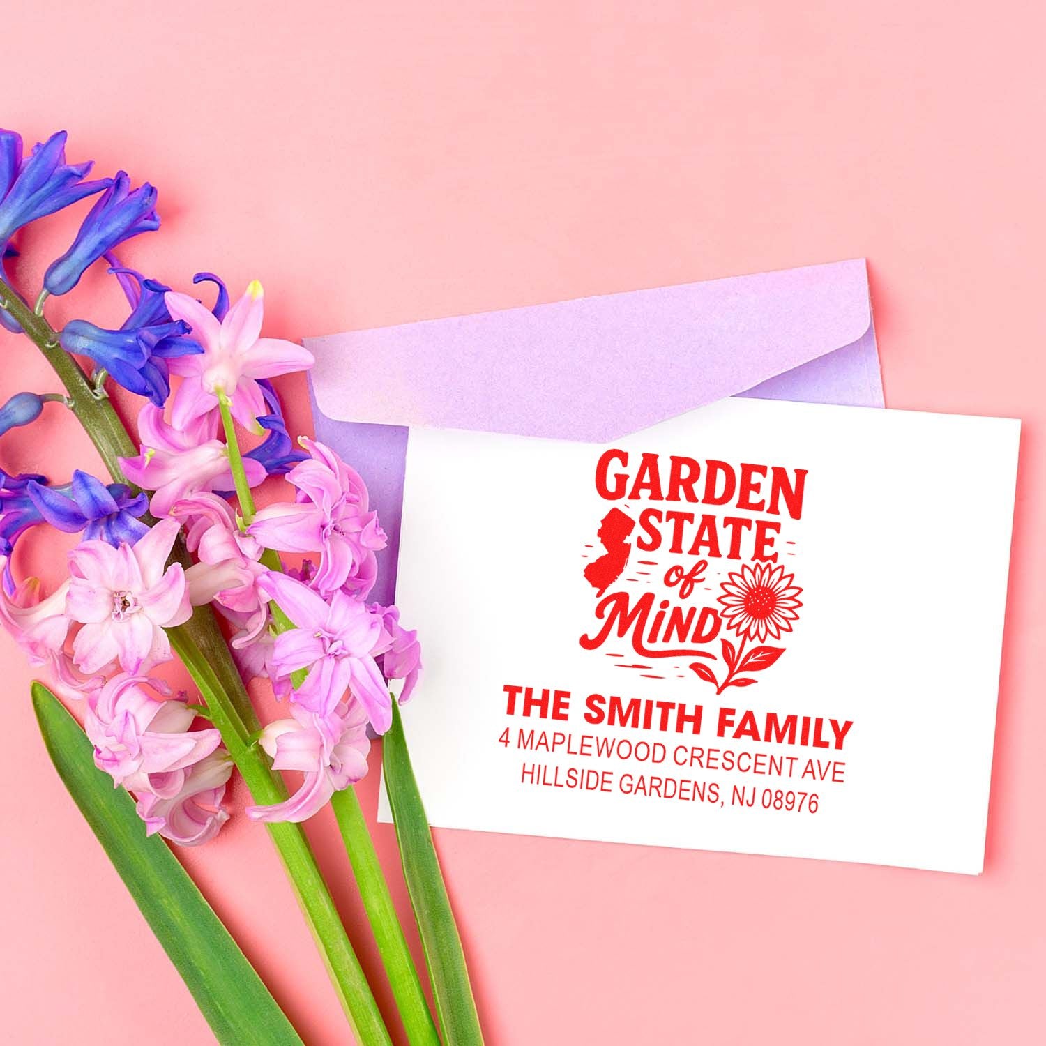 Custom floral return address rubber stamp on envelope, featuring Garden State of Mind design for family mailings.