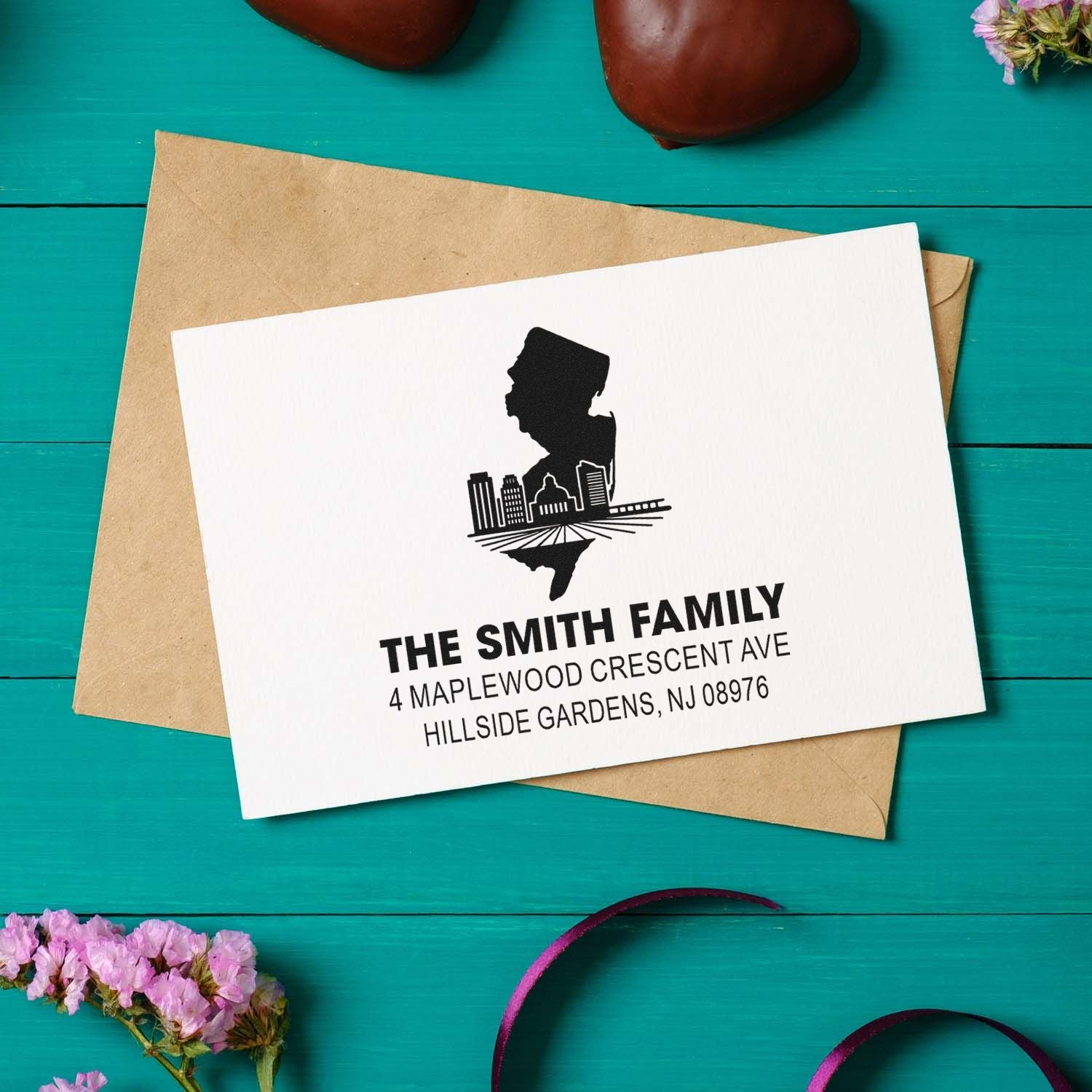 Personalized family return address rubber stamp with city skyline design for envelopes and stationery.
