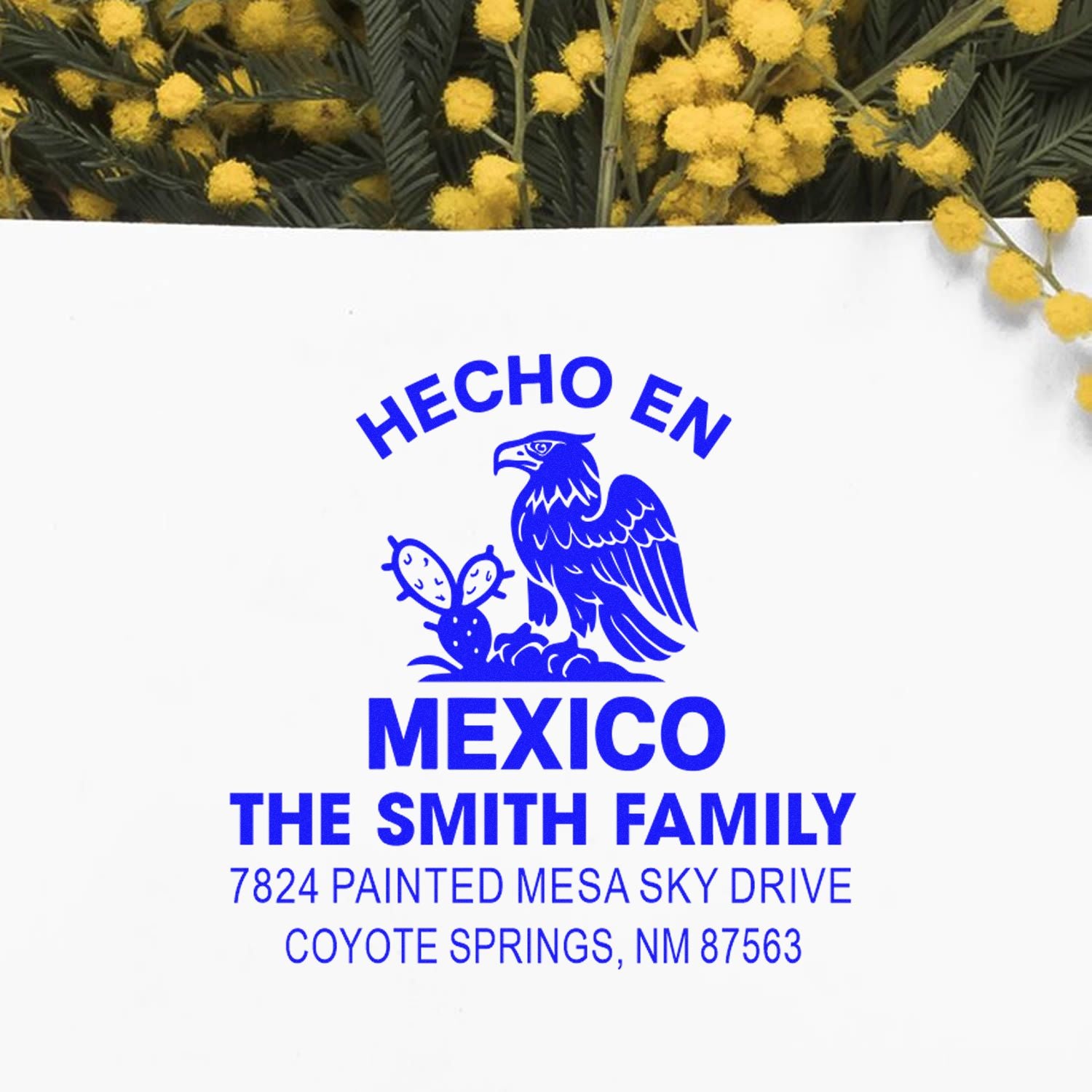 Custom rubber stamp impression reading Hecho en Mexico for The Smith Family, with eagle logo and Coyote Springs, NM address.