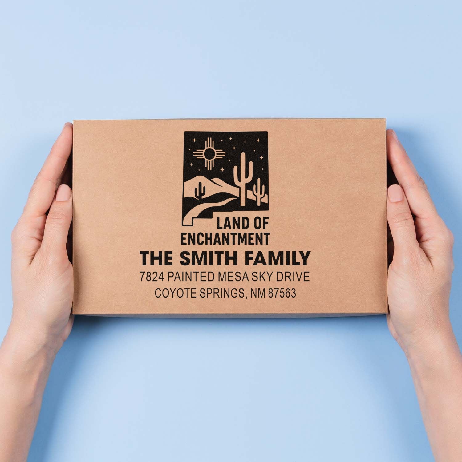 Custom return address rubber stamp on kraft box with Southwest cactus design for personalized packaging.