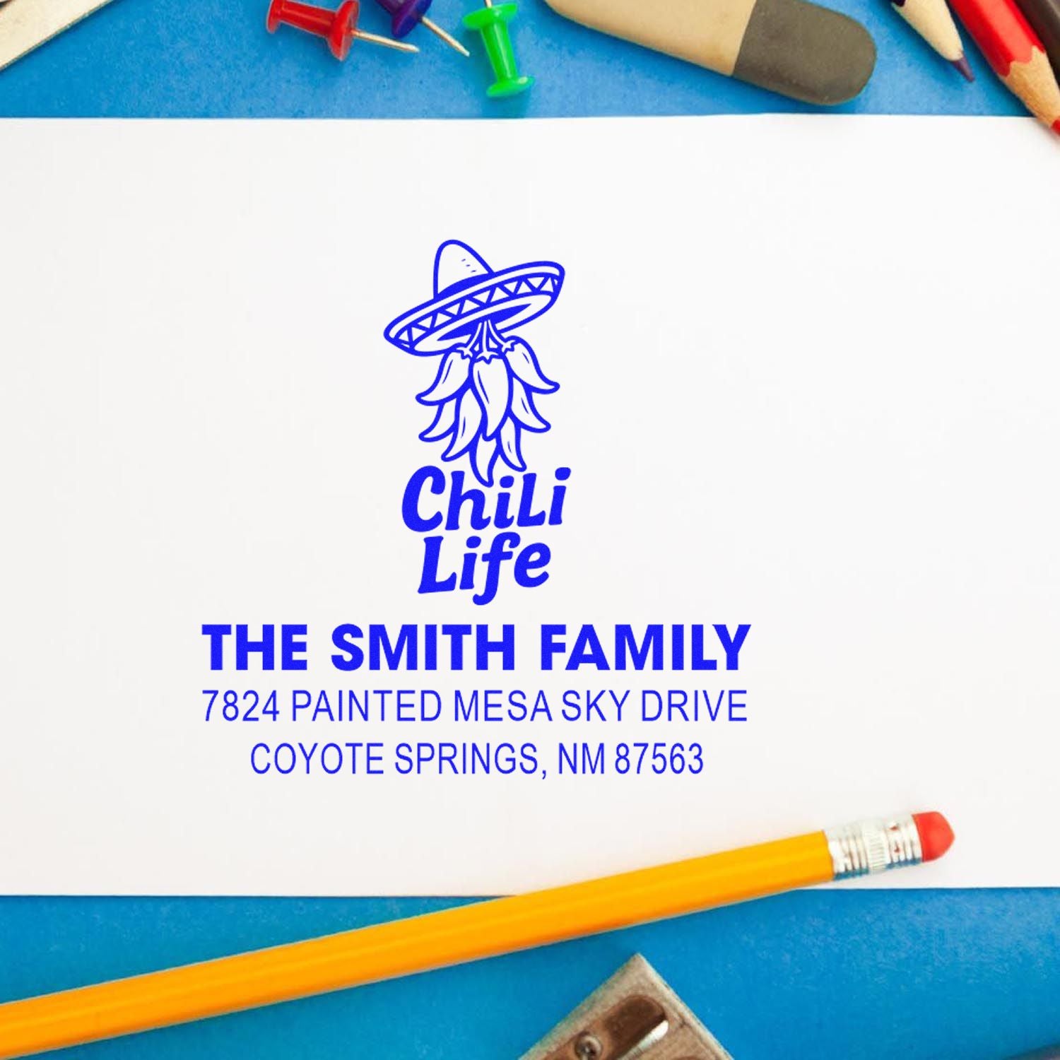 Custom rubber return address stamp with chili logo for The Smith Family, Coyote Springs, NM 87563.