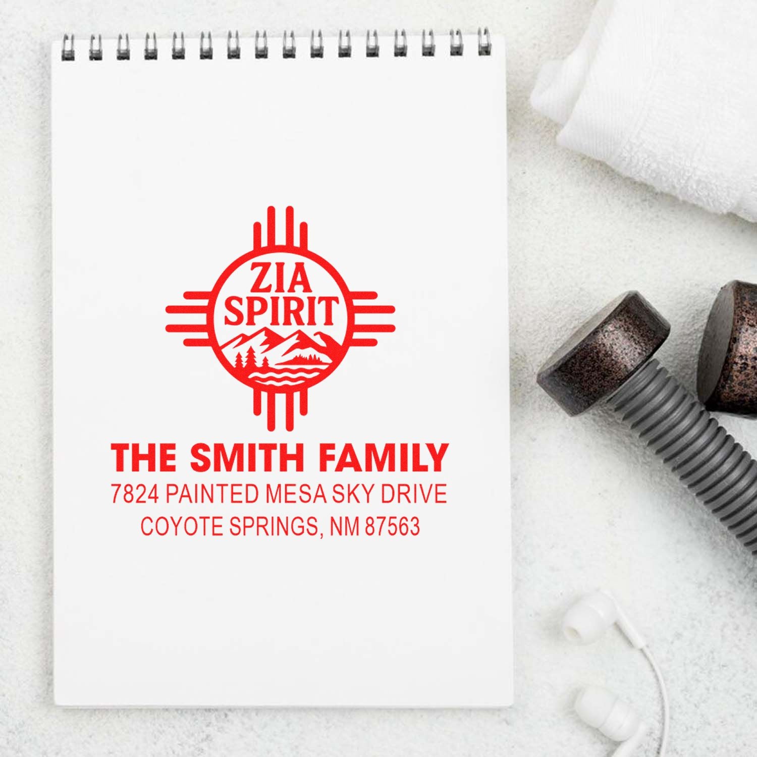 Custom Zia Spirit family address rubber stamp on notebook mockup for The Smith Family, Coyote Springs, NM