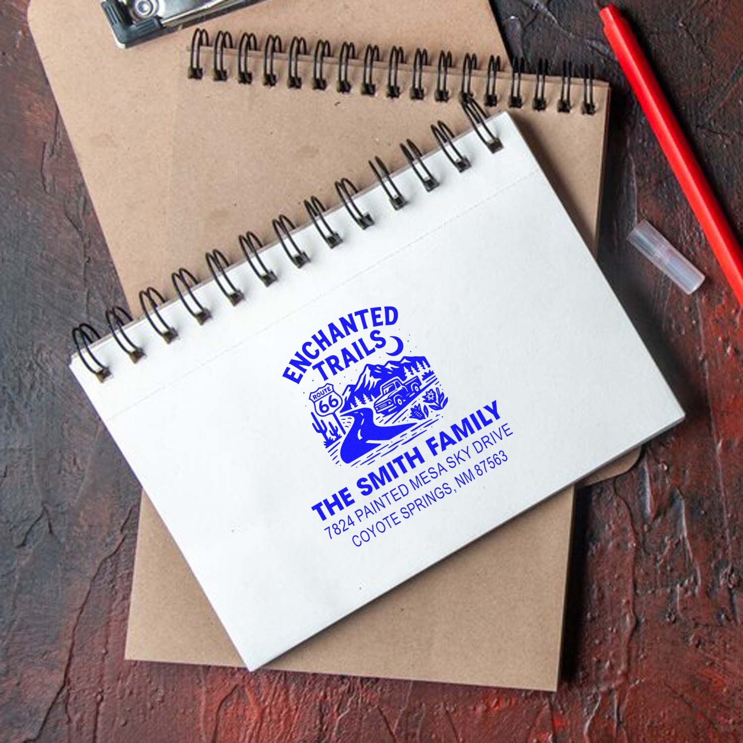 Custom family return address rubber stamp with Enchanted Trails design on a notebook, ideal for personalized stationery.