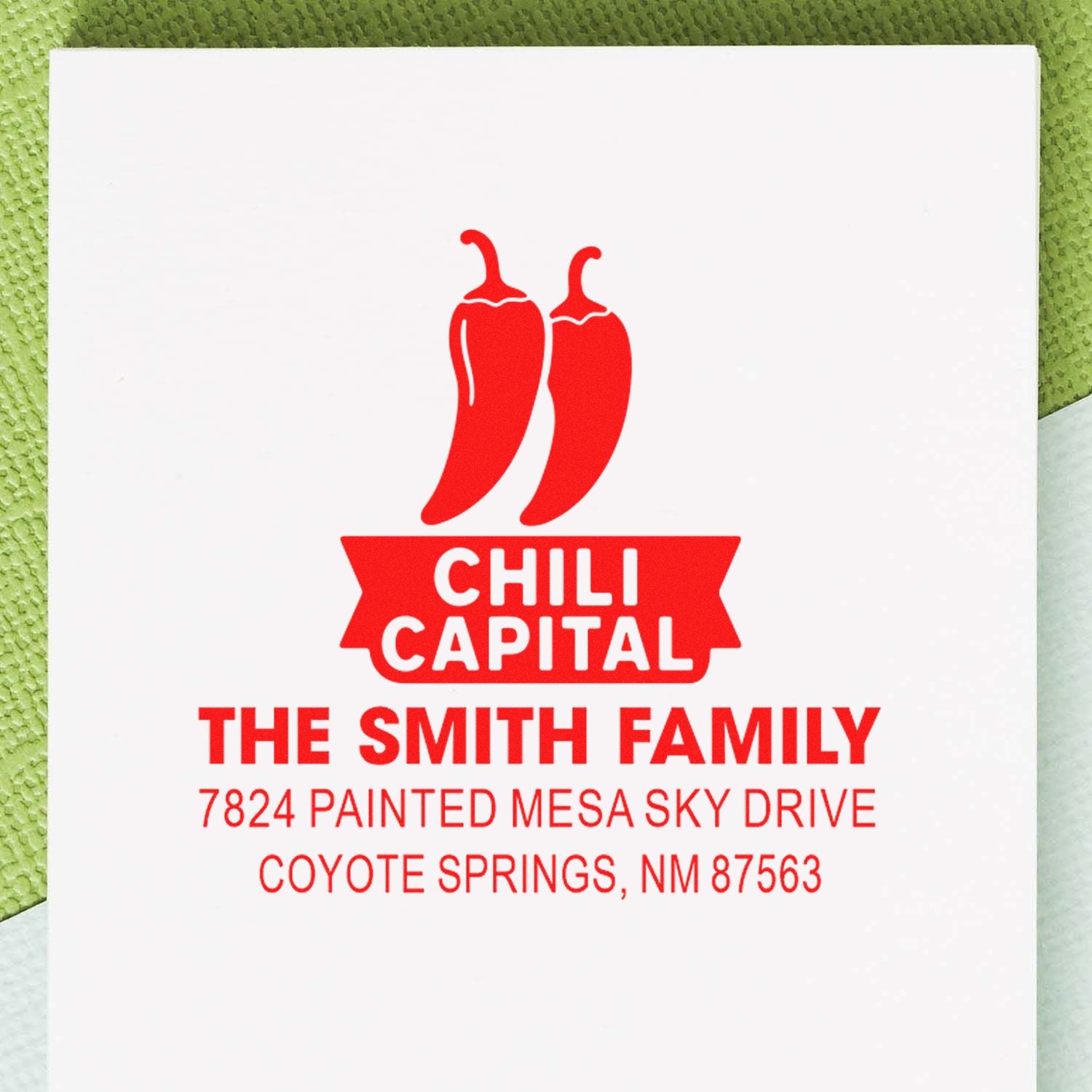 Custom rubber stamp return address with chili pepper logo for The Smith Family, Coyote Springs, NM 87563.