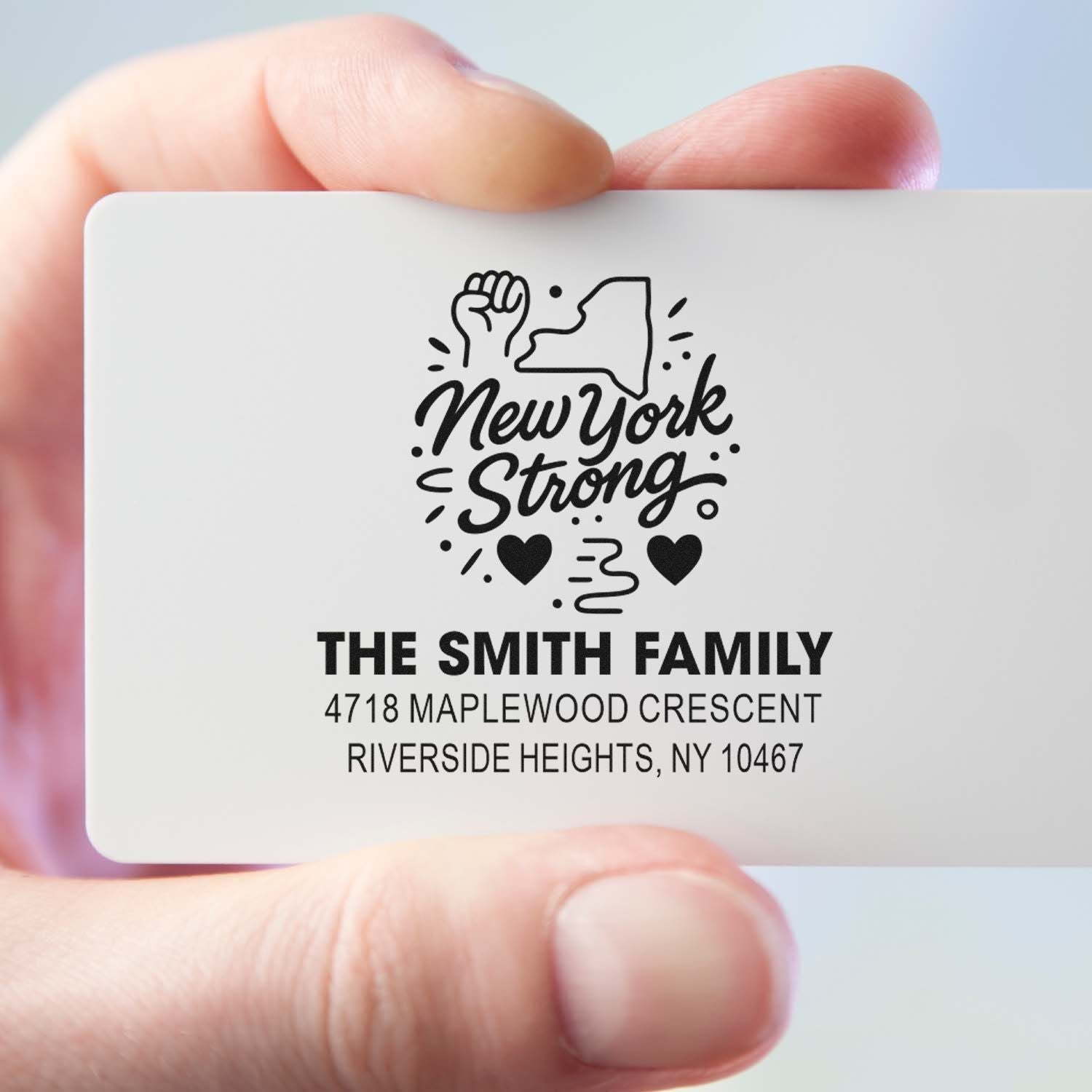 Custom New York Strong rubber stamp with family name and address for personalized mailing and support-themed branding.