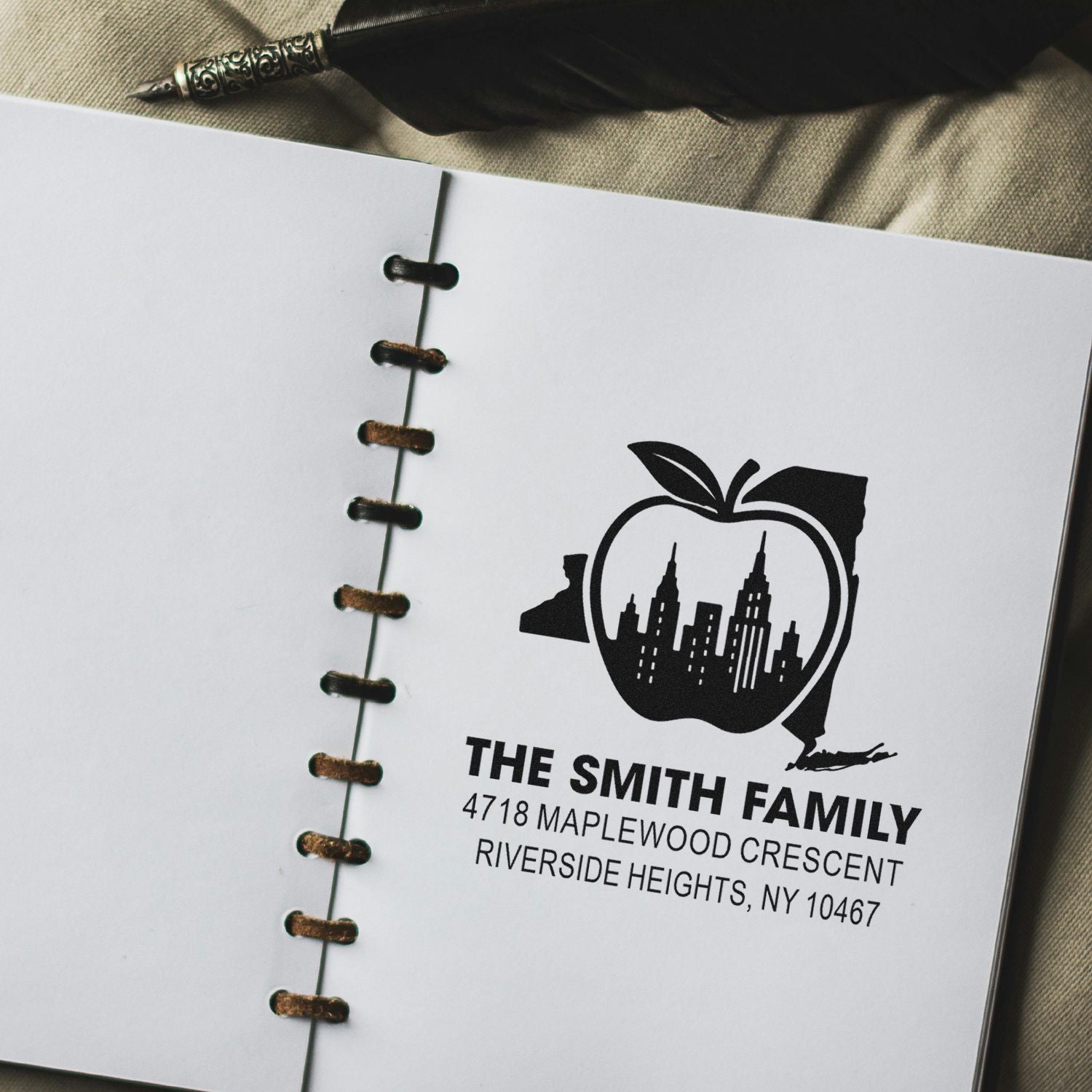 Custom rubber address stamp with apple skyline design for The Smith Family, featuring name and full mailing address.