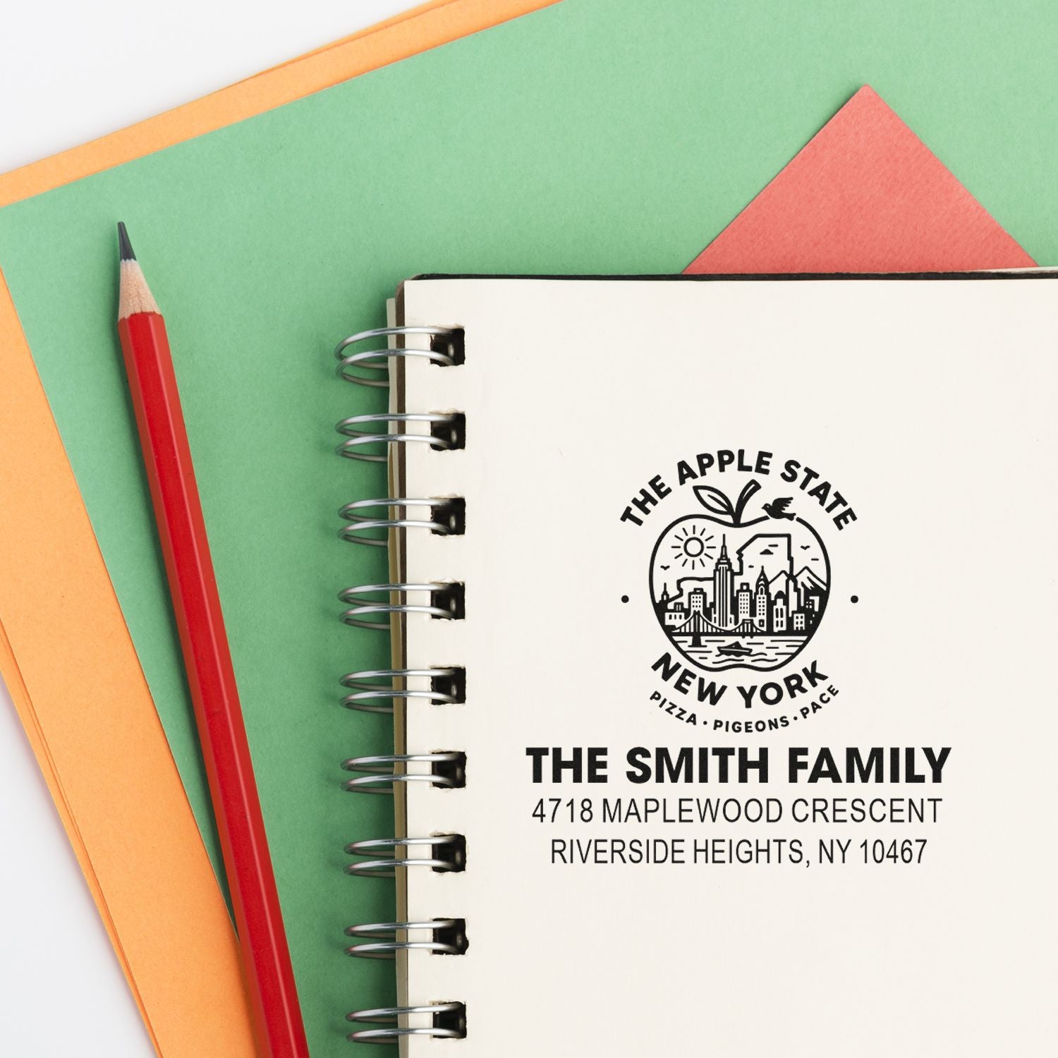 Custom New York return address rubber stamp on notebook, featuring The Smith Family name and Riverside Heights, NY 10467.