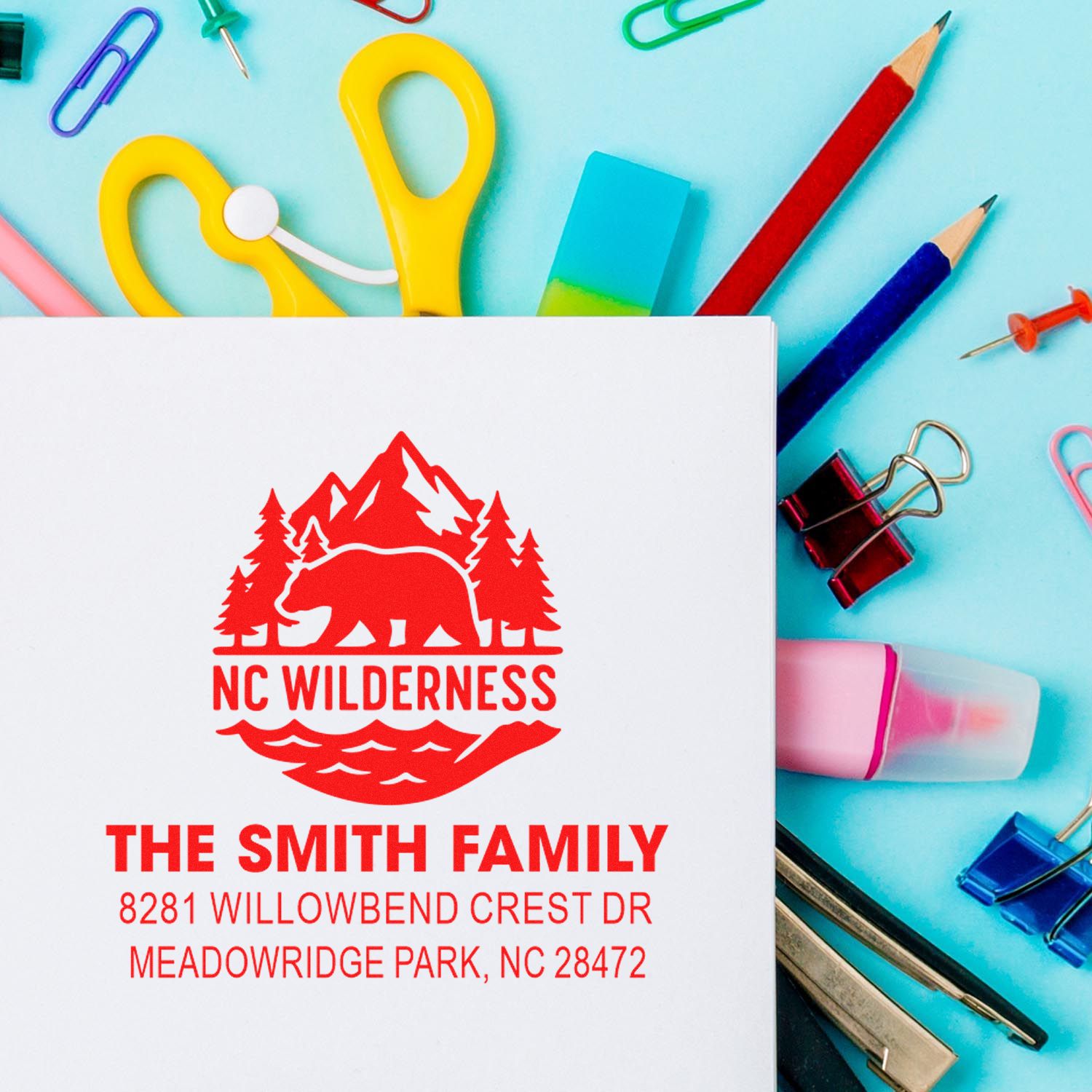 Custom return address rubber stamp with NC wilderness bear logo for The Smith Family stationery.