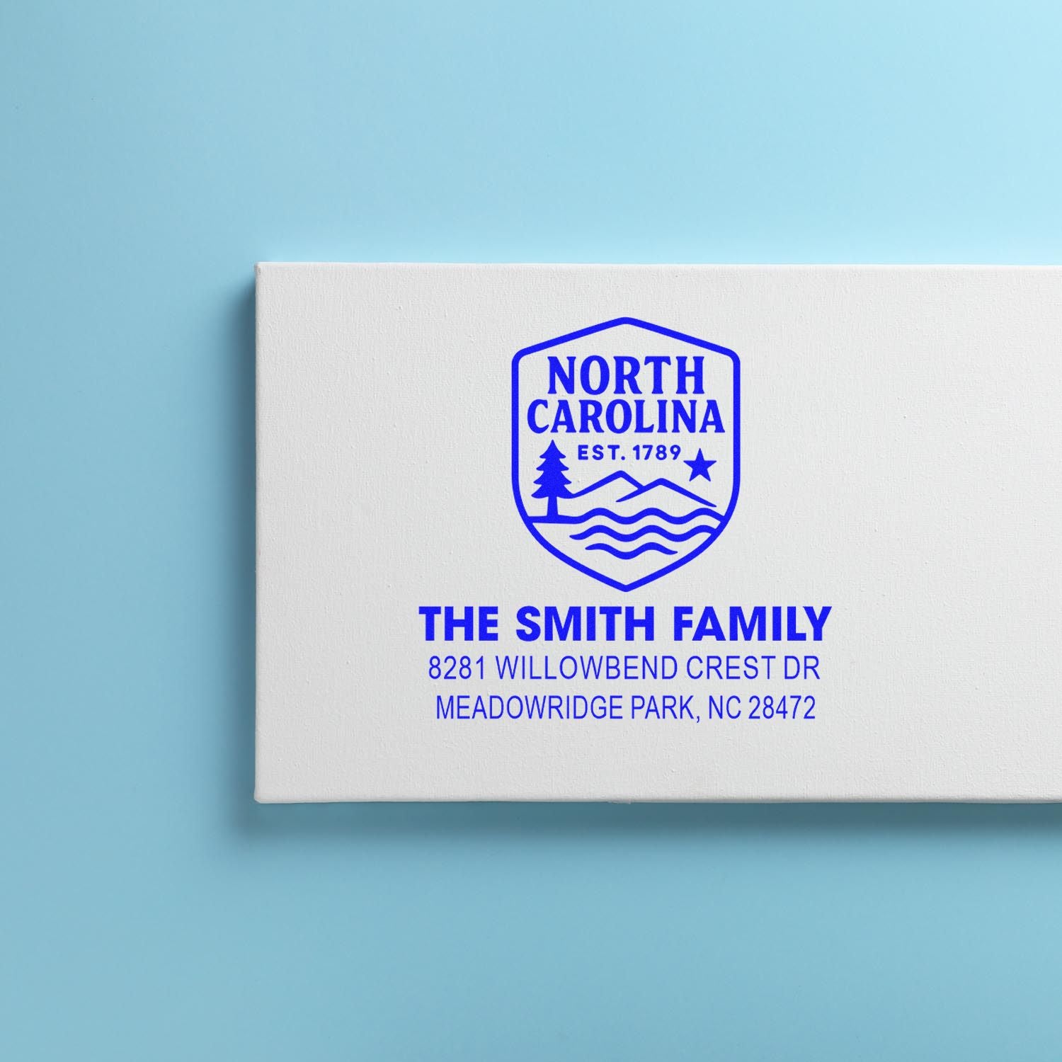 Custom North Carolina return address rubber stamp for The Smith Family on white packaging