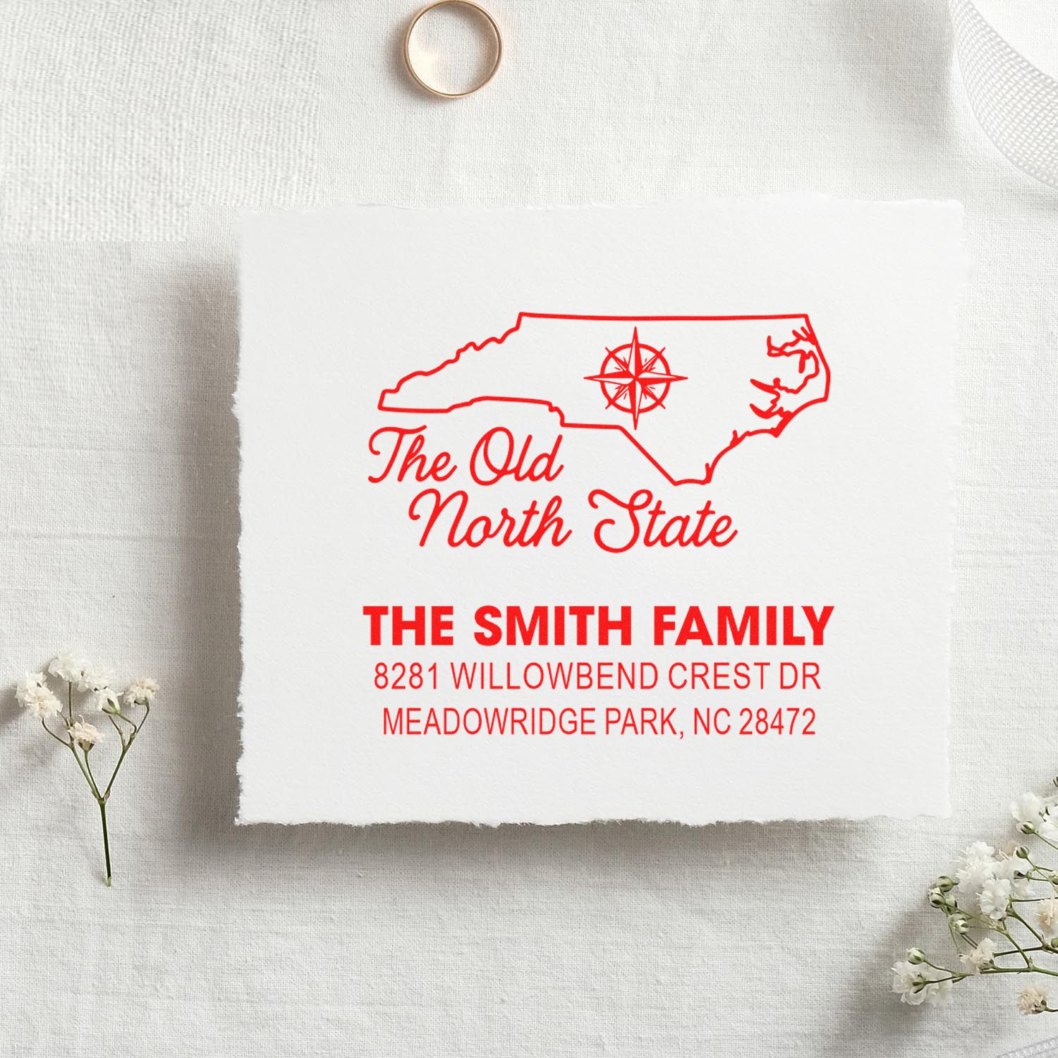 Custom North Carolina return address rubber stamp for The Smith Family with state outline and compass design.