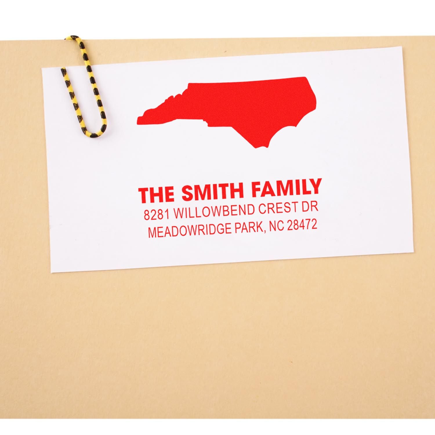 Custom North Carolina return address rubber stamp with family name, state silhouette, and mailing address.