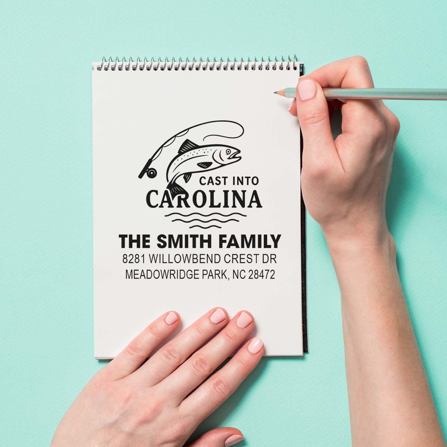 Custom rubber stamp design with fish and fishing rod, featuring Cast Into Carolina and The Smith Family return address for North Carolina.