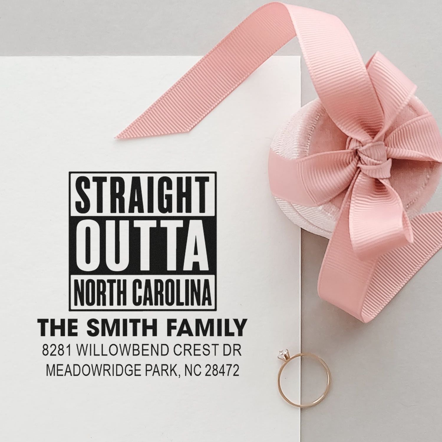 Personalized rubber address stamp for The Smith Family, Straight Outta North Carolina design, on a pink ribbon envelope.