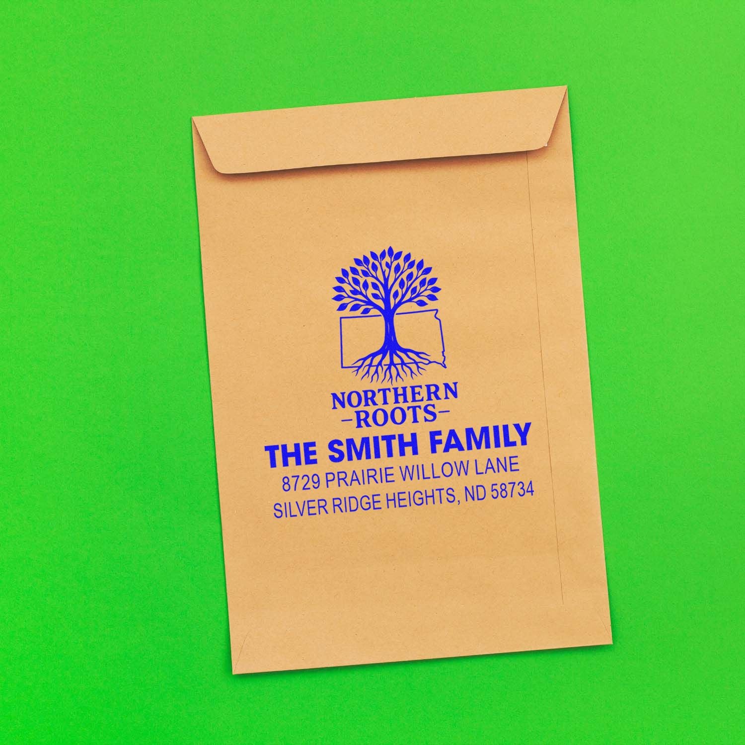 Custom return address rubber stamp on kraft envelope with tree logo and family name for Northern Roots mailing.