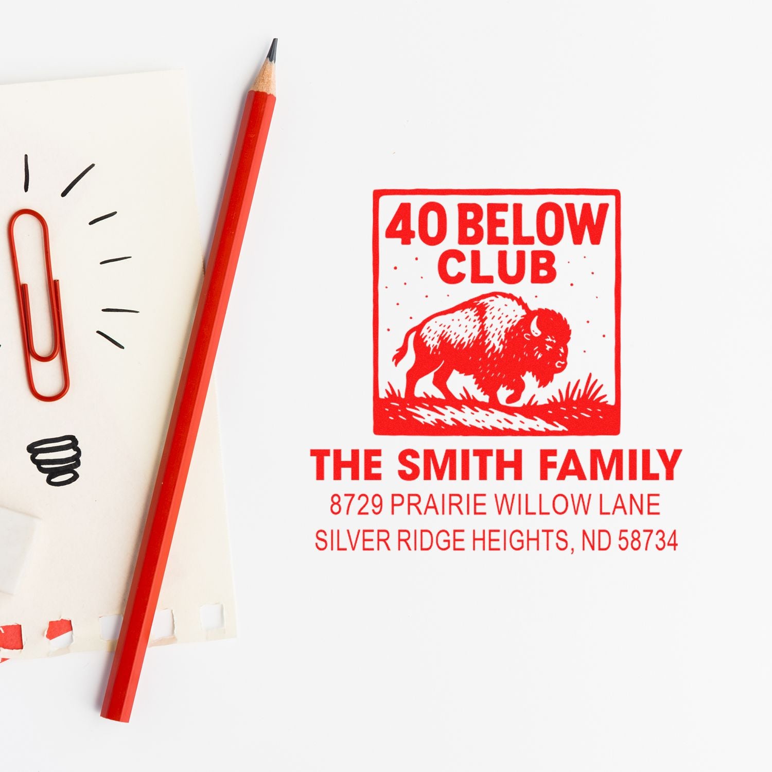 Custom rubber address stamp with 40 Below Club bison design for The Smith Family, shown in red ink on paper.