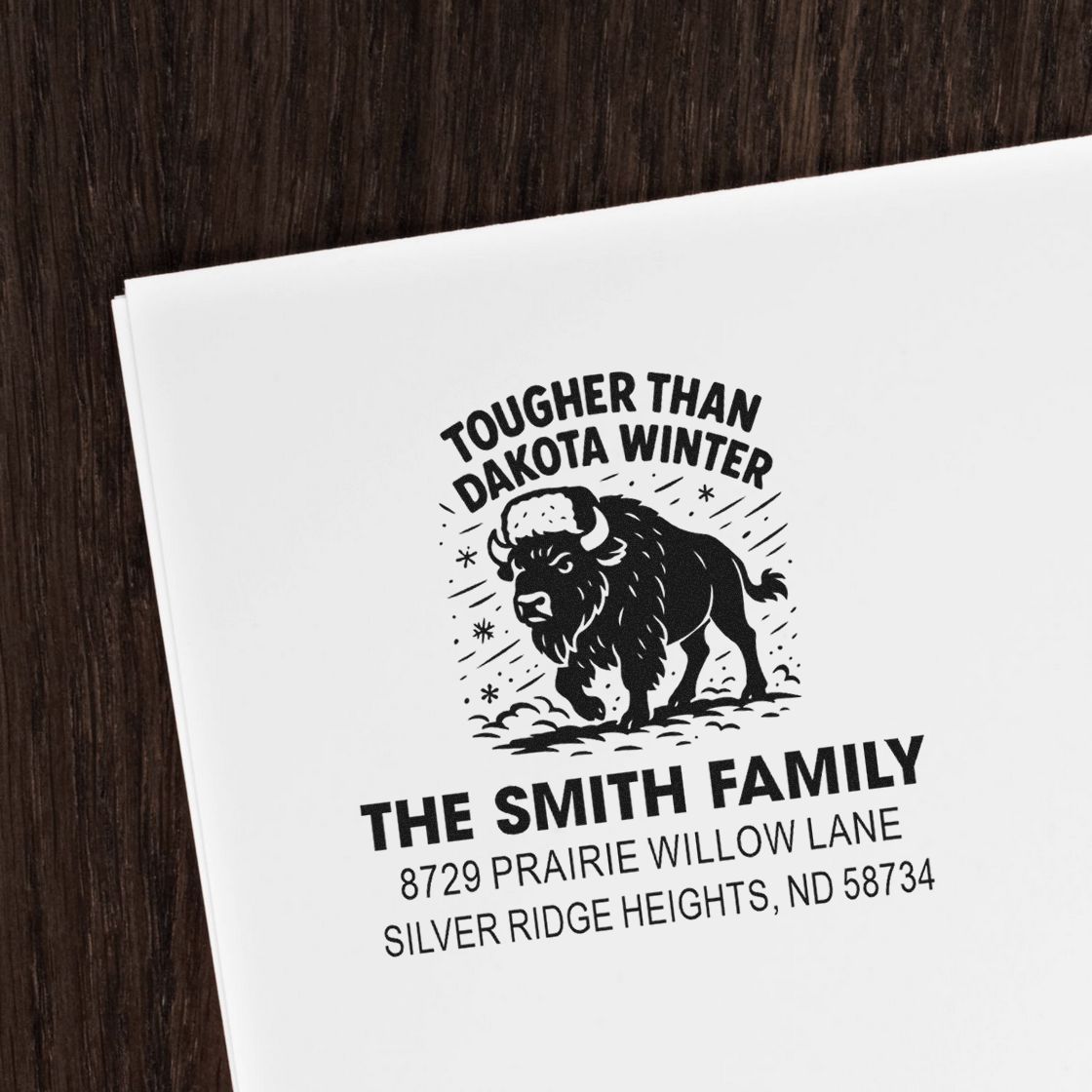 Custom rubber stamp impression with buffalo graphic, Tougher Than Dakota Winter, and Smith family address for mailings.