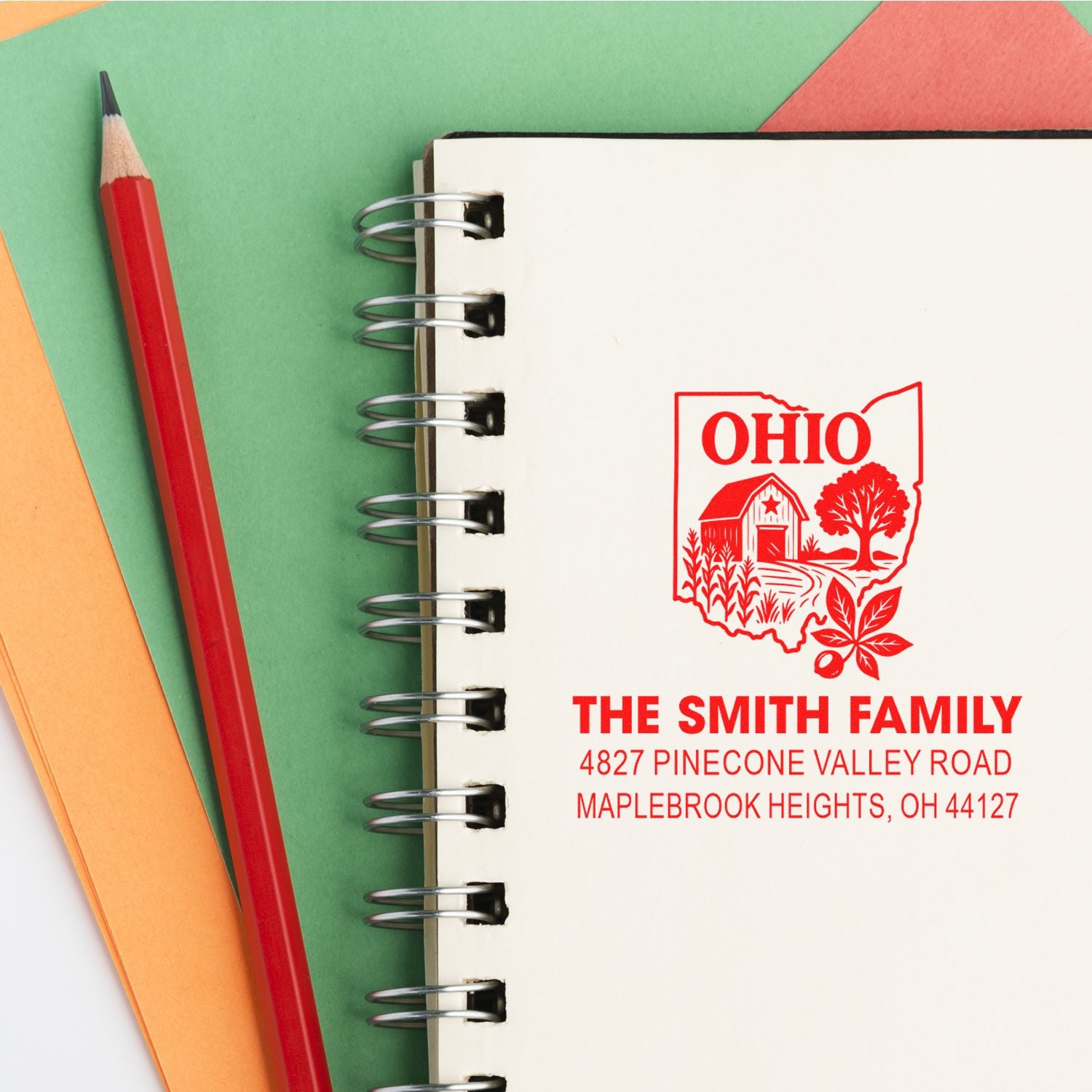 Custom Ohio family address rubber stamp on notebook, showing The Smith Family name and Maplebrook Heights, OH return address.