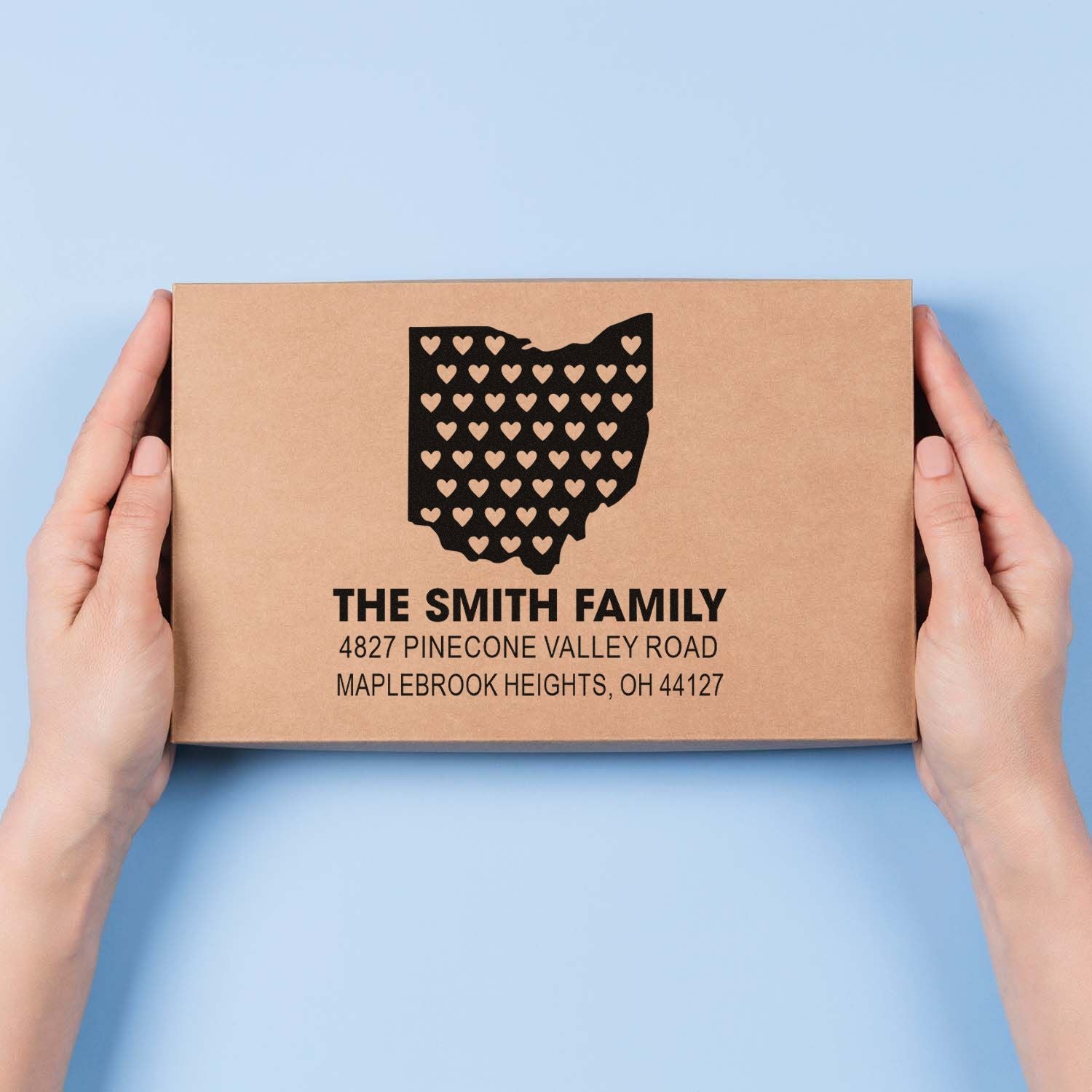 Custom return address rubber stamp design on kraft box, featuring Ohio hearts and personalized family mailing label.