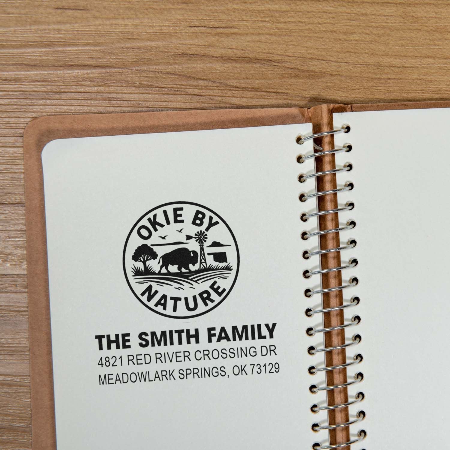 Custom rubber address stamp for The Smith Family with Okie by Nature Oklahoma design on a notebook page.