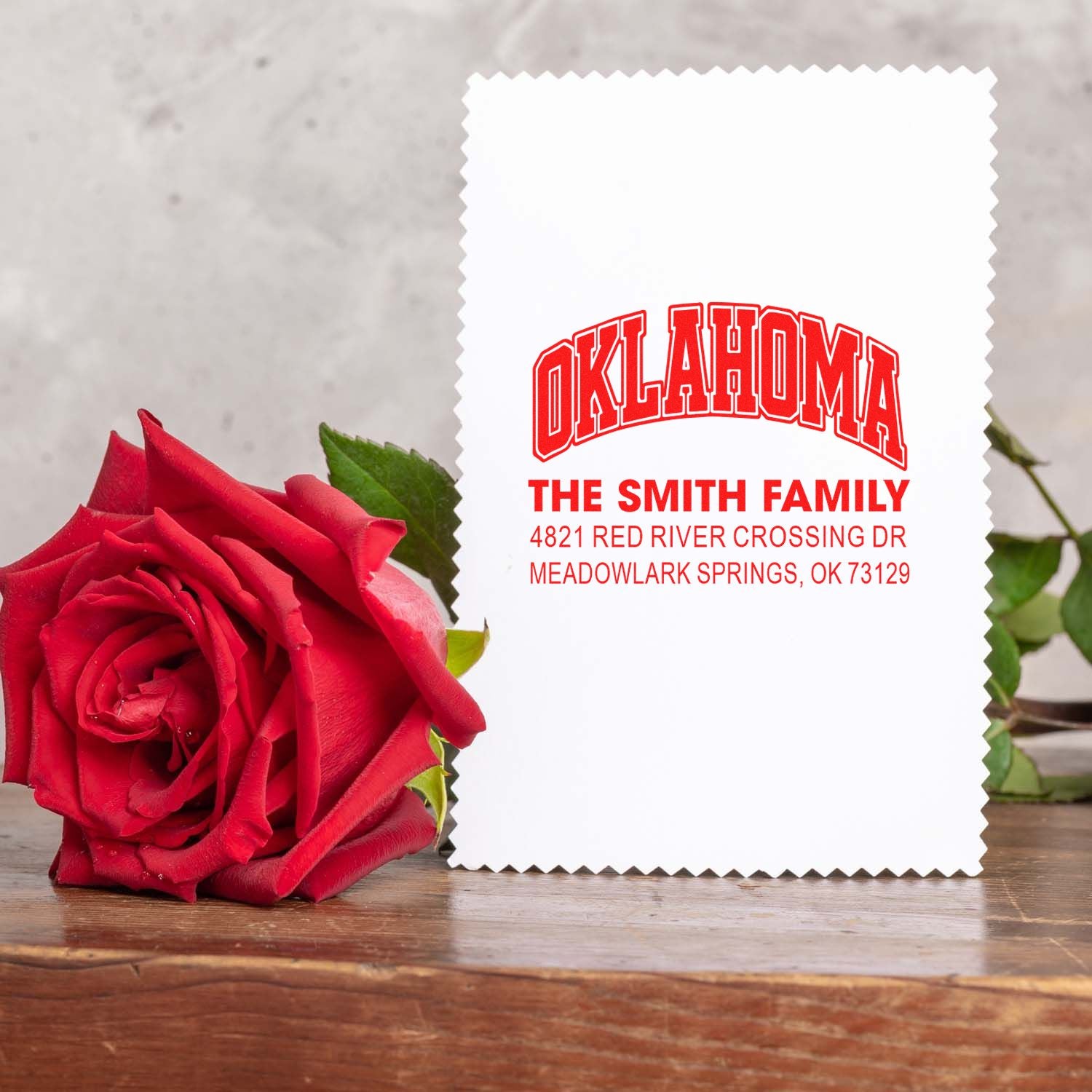 Personalized Oklahoma family return address rubber stamp with Smith family name and address, displayed beside a red rose.