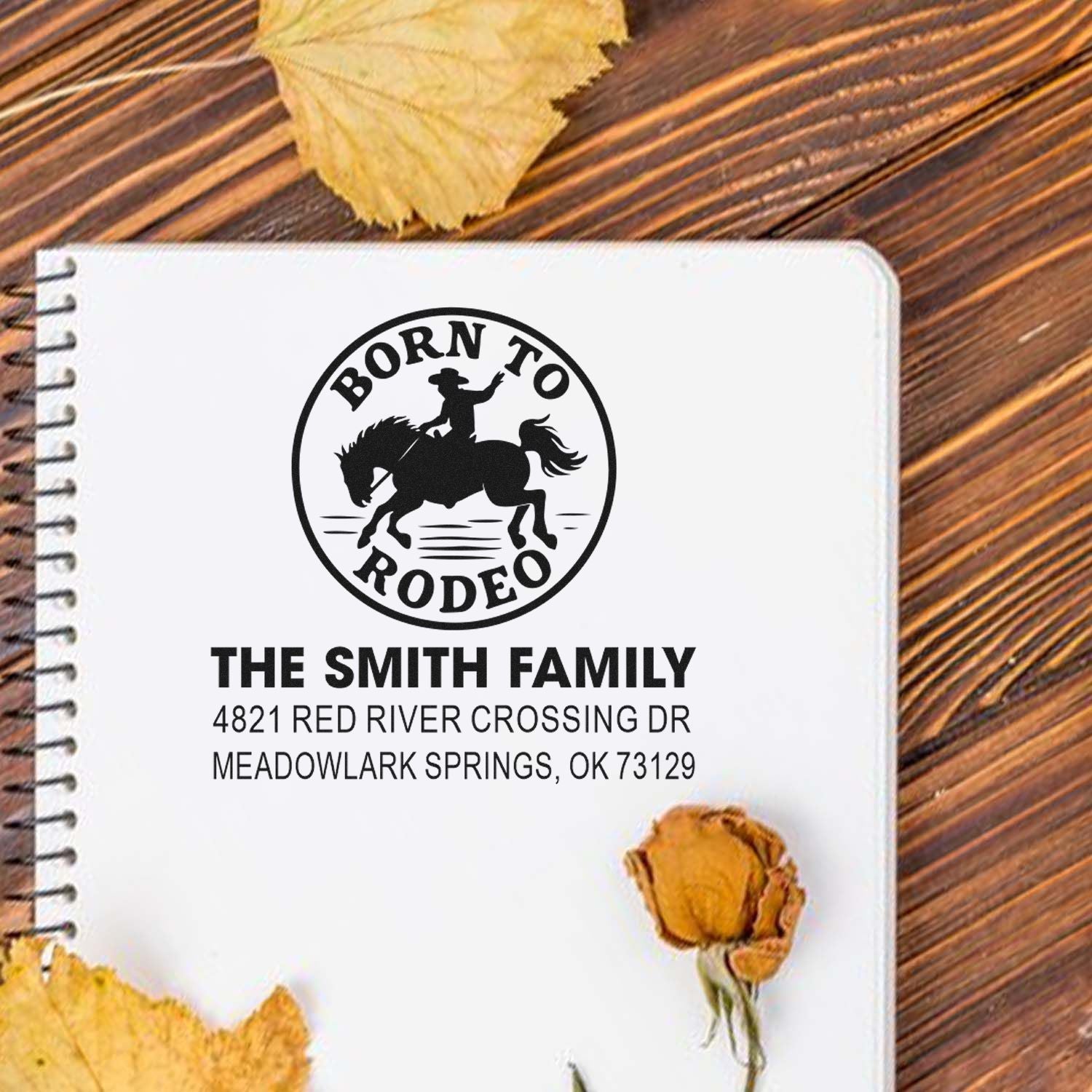 Custom rubber stamp with Born to Rodeo cowboy logo and Smith family return address on a notebook.