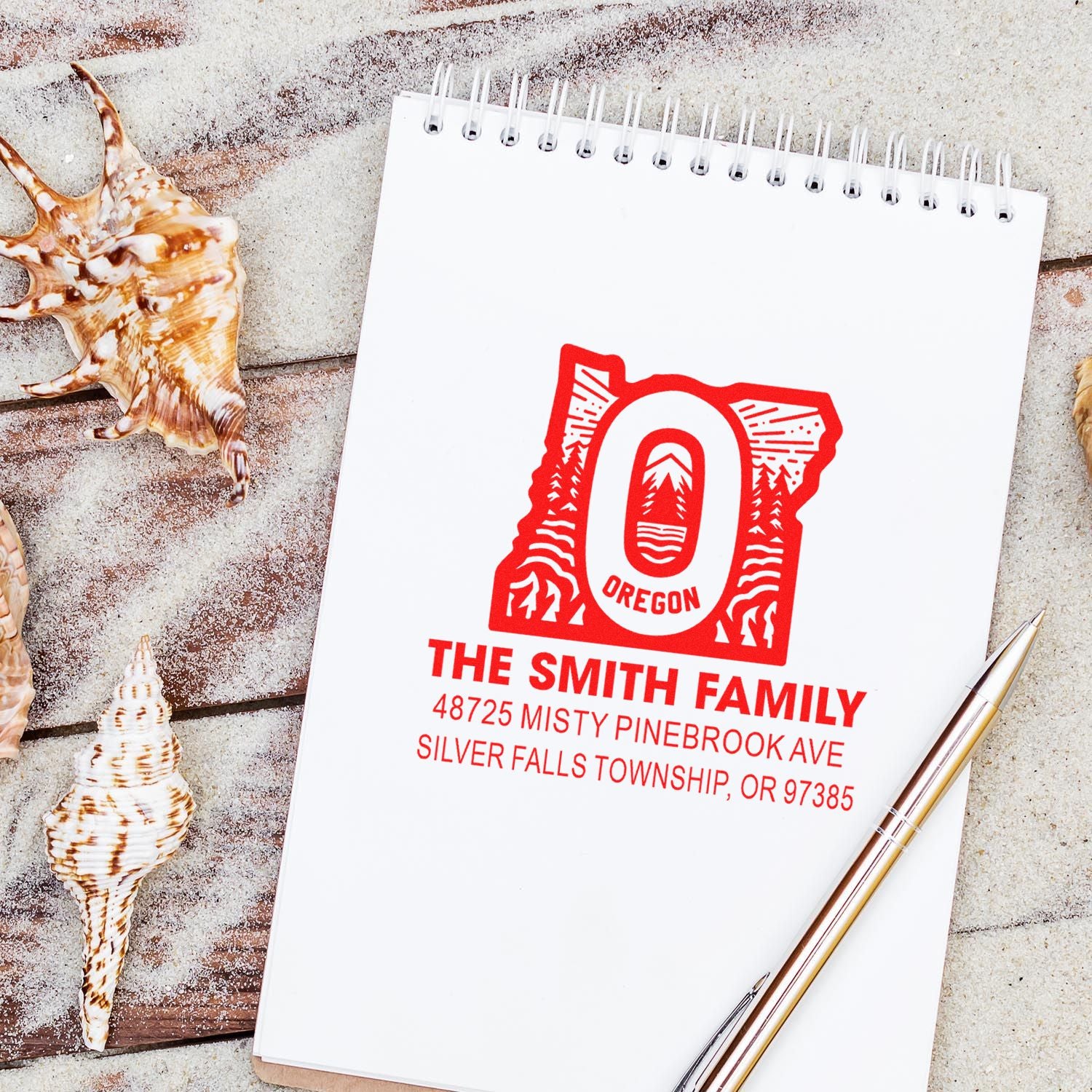 Personalized Oregon return address rubber stamp for The Smith Family with custom mailing address on a notebook.