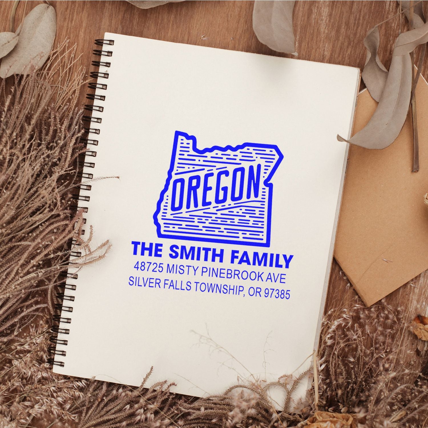 Custom Oregon return address rubber stamp with Smith family name and address on notebook.
