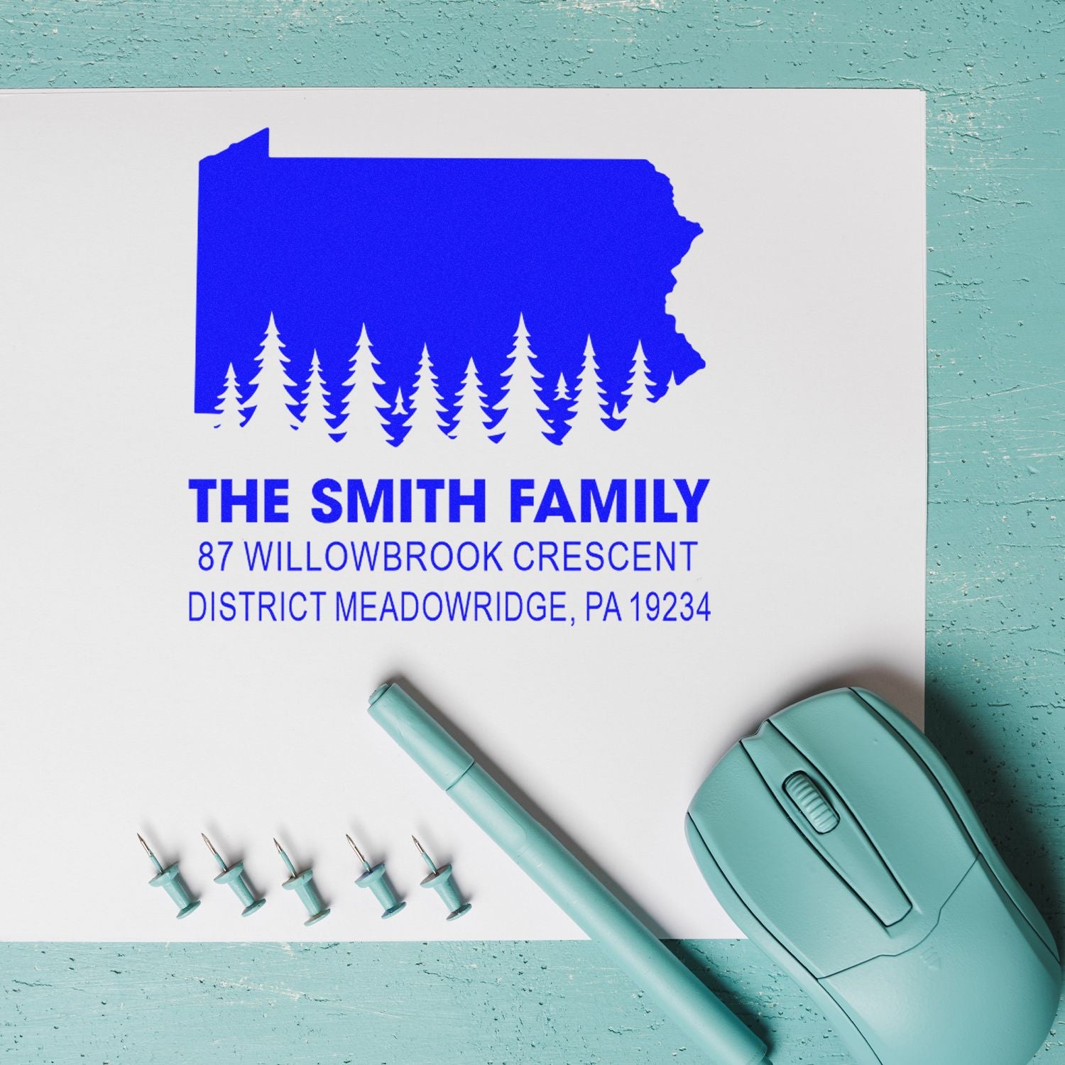 Custom self-inking family return address rubber stamp with Pennsylvania silhouette and pine tree design for personalized mailings.