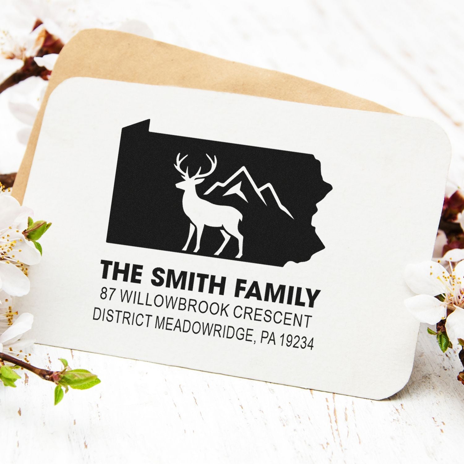 Custom rubber return address stamp with deer and mountain logo for The Smith Family