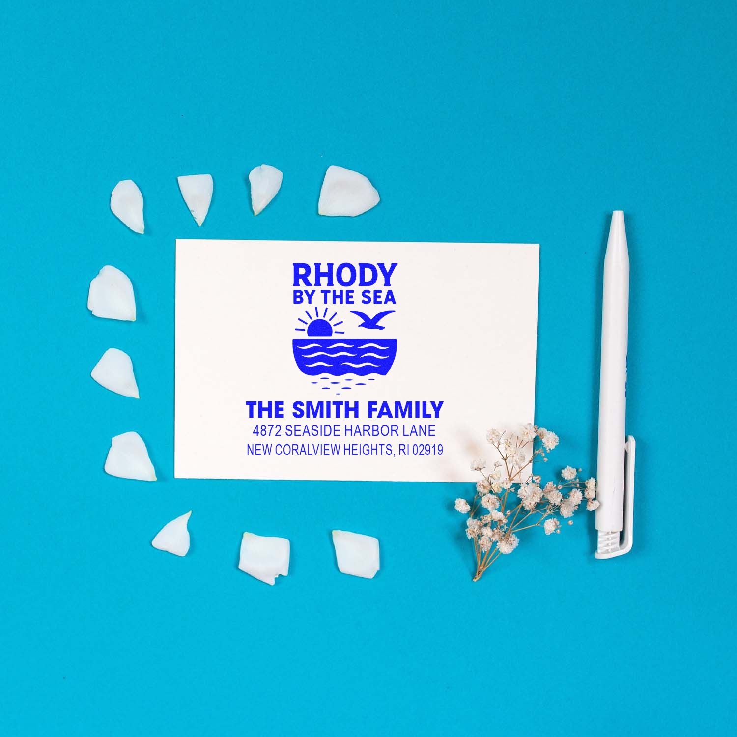 Custom coastal return address rubber stamp for The Smith Family with seaside logo on white card and stamp tool.