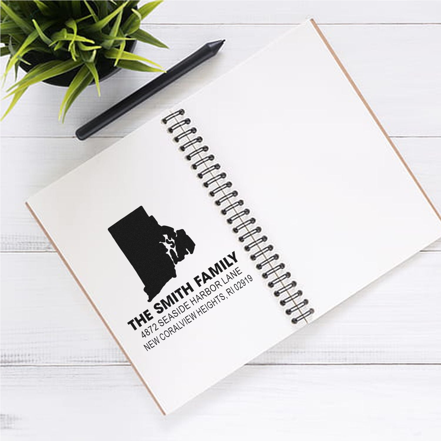 Custom return address rubber stamp for The Smith Family, showing a Rhode Island address on a notebook.