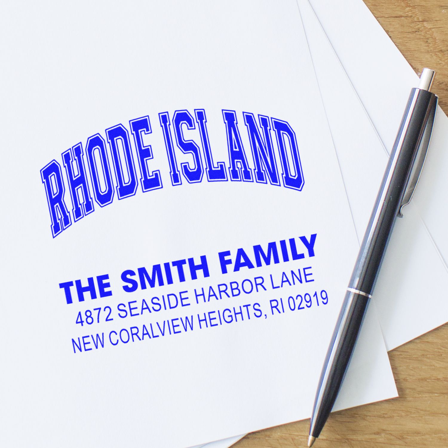 Personalized return address rubber stamp with Rhode Island family name and mailing address on paper