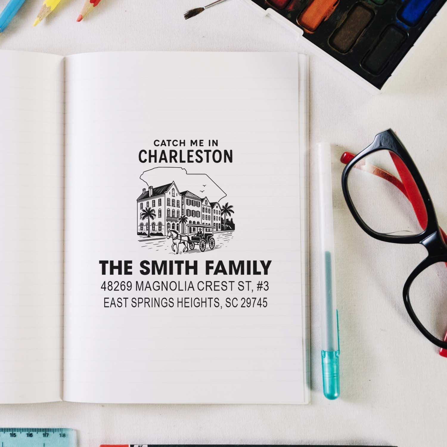 Personalized Charleston family rubber address stamp with name and address on a notebook mockup